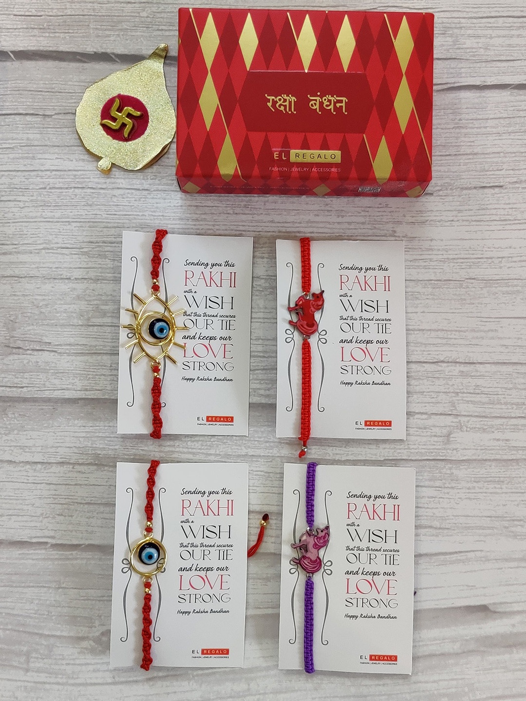 EL REGALO Set Of 4 Red Wrap Around Rakhi With Roli Chawal & Raksha Bandhan Greeting Card
EL REGALO Set Of 4 Red Wrap Around Rakhi With Roli Chawal & Raksha Bandhan Greeting Card