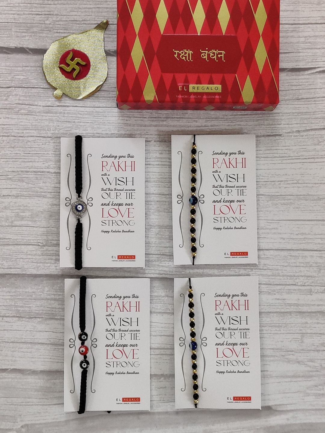 EL REGALO Set Of 4 Evil Eye Wrap Around Rakhi With Roli Chawal & Greeting Card, Gold
EL REGALO Set Of 4 Evil Eye Wrap Around Rakhi With Roli Chawal & Greeting Card, Gold
