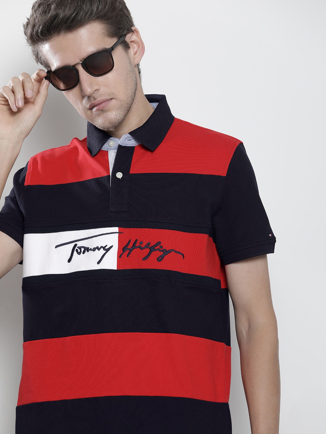 Tommy Hilfiger Men Navy Blue & Red Colourblocked Polo Collar Applique T-shirt
Tommy Hilfiger Men Navy Blue & Red Colourblocked Polo Collar Applique T-shirt
