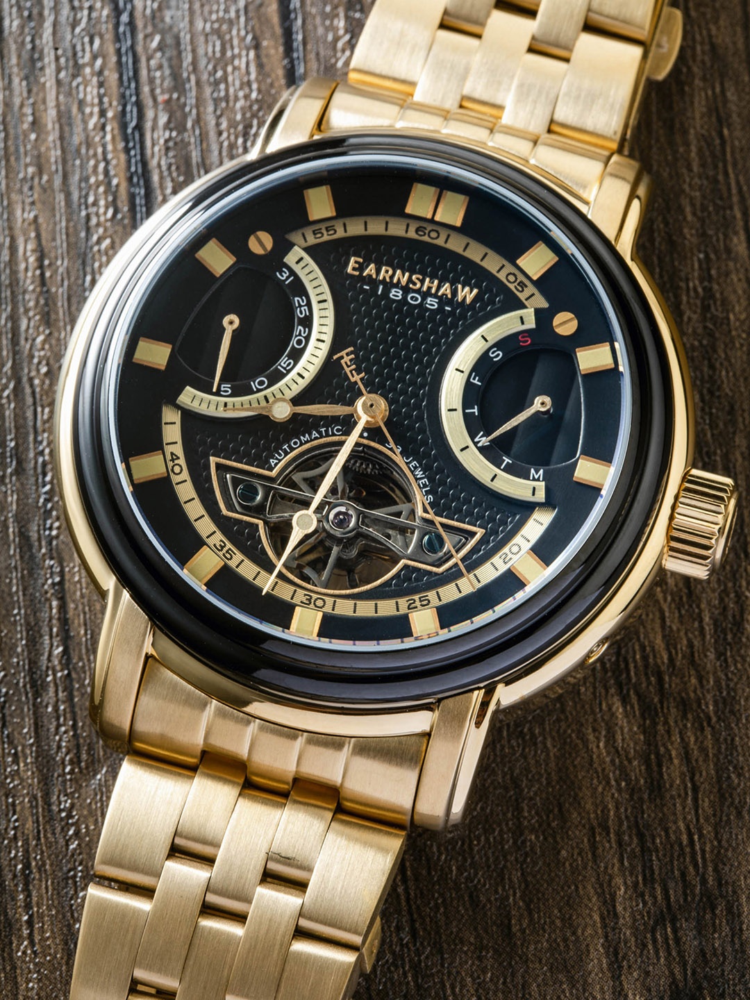 EARNSHAW Men Black Brass Embellished Dial & Gold Toned Stainless Steel Analogue Watch
EARNSHAW Men Black Brass Embellished Dial & Gold Toned Stainless Steel Analogue Watch