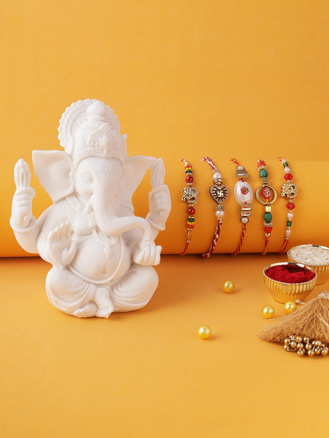 Aapno Rajasthan Set of 5 White & Red Thread Rakhi With Ganesha Idol, Roli Chawal & Raksha Bandhan Greeting Card
Aapno Rajasthan Set of 5 White & Red Thread Rakhi With Ganesha Idol, Roli Chawal & Raksha Bandhan Greeting Card