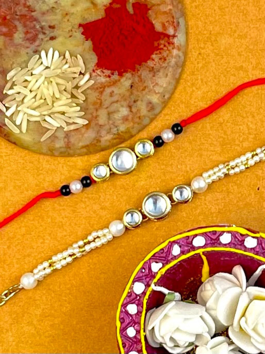 KARATCART Pack of 2 Red & White Gold-Plated Kundan-Studs & Beaded Bhaiye Bhabhi Rakhi 
KARATCART Pack of 2 Red & White Gold-Plated Kundan-Studs & Beaded Bhaiye Bhabhi Rakhi