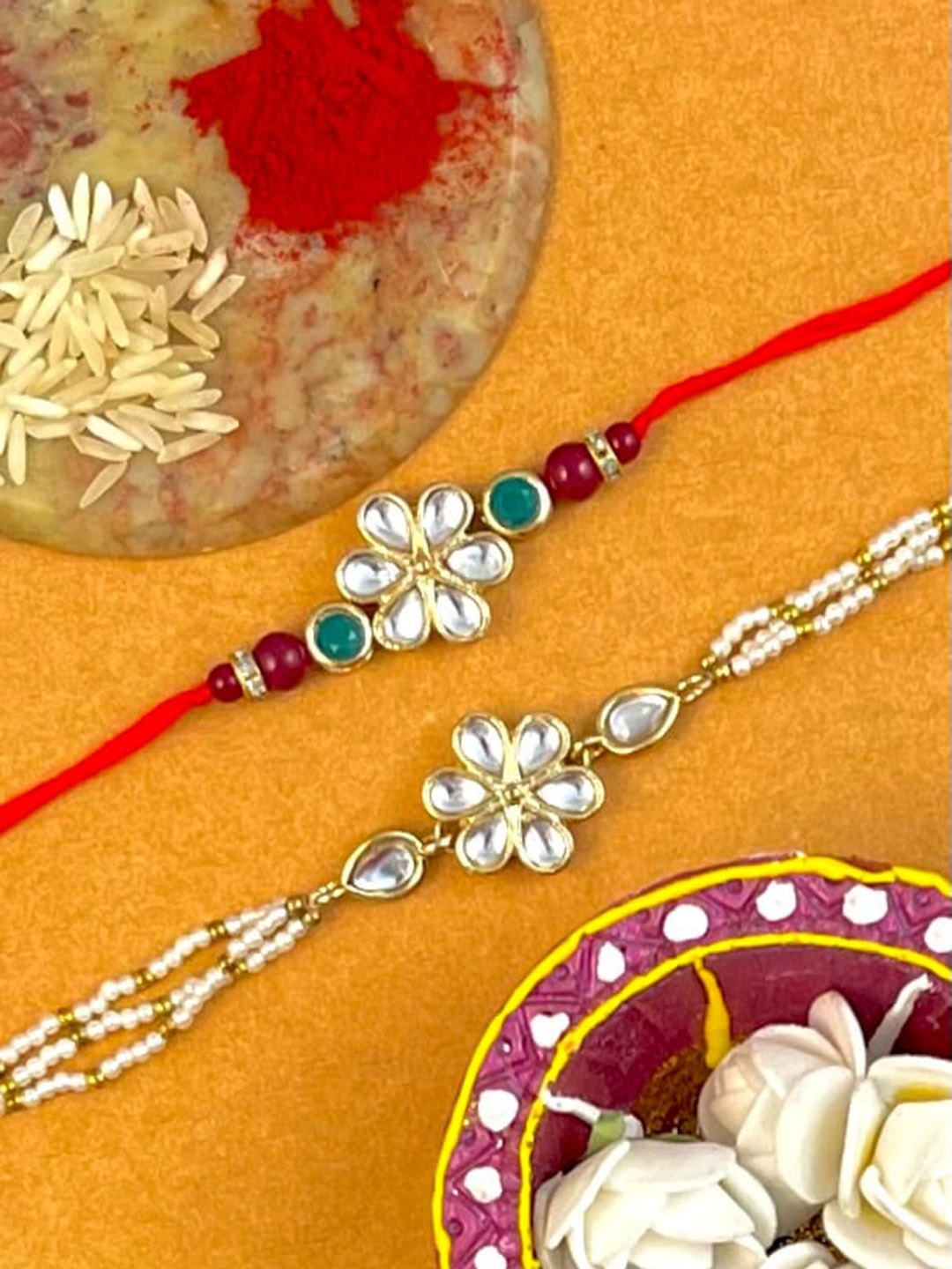 KARATCART Set Of 2 Gold-Toned & White Stone-Studded & Beaded Rakhi With Roli & Chawal
KARATCART Set Of 2 Gold-Toned & White Stone-Studded & Beaded Rakhi With Roli & Chawal