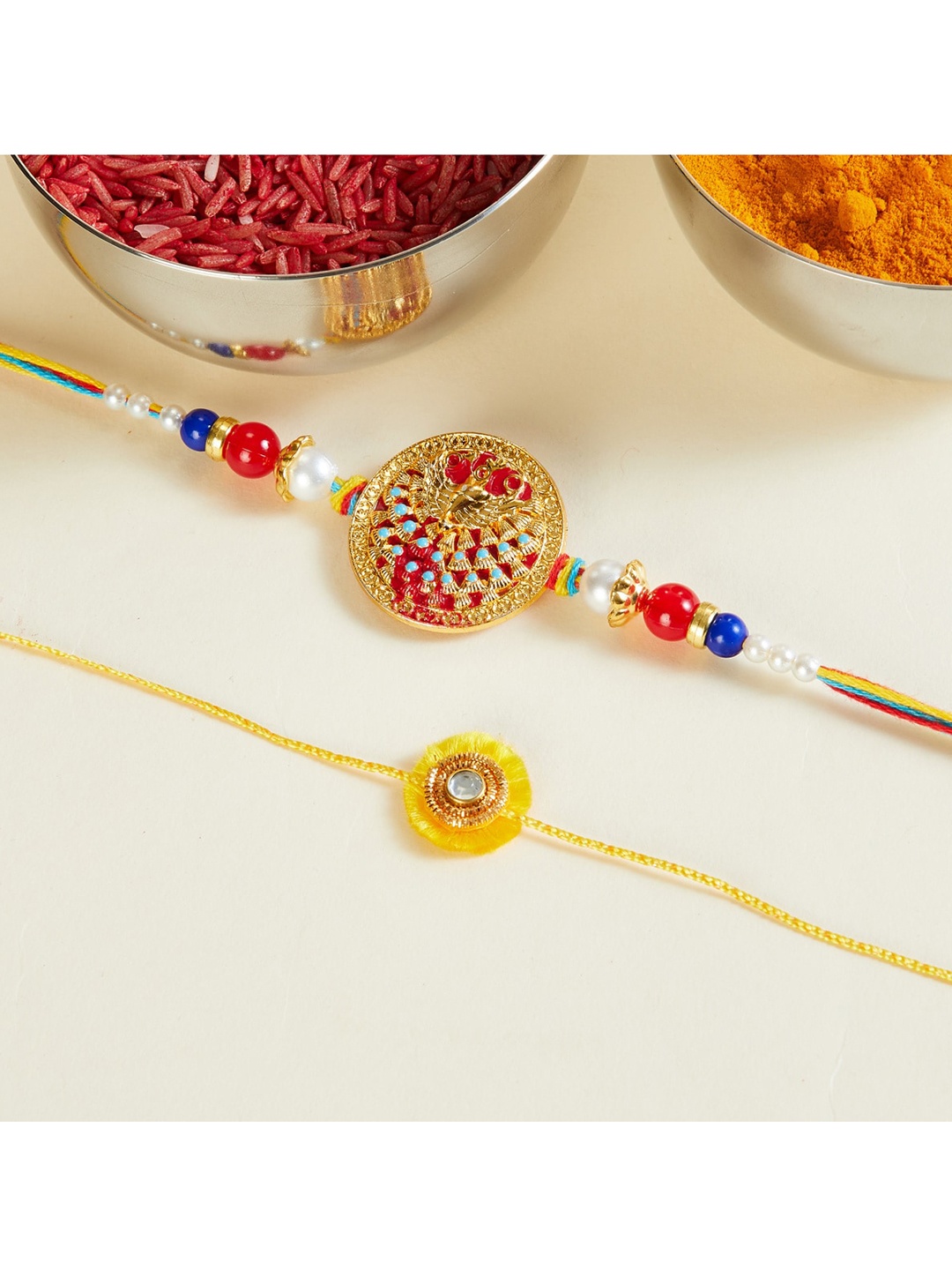 Home Centre Set of 2 Yellow Red Corsica Textured Cotton Enamel Peacock Rakhi