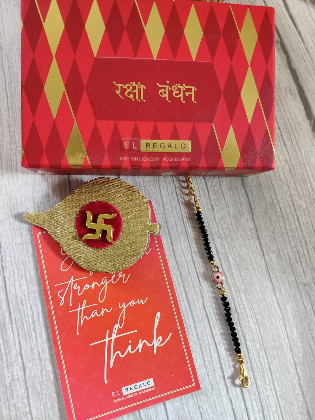 EL REGALO Gold Coloured Evil Eye Baby Rakhi With Roli Chawal Raksha Bandhan Card, Pink
EL REGALO Gold Coloured Evil Eye Baby Rakhi With Roli Chawal Raksha Bandhan Card, Pink