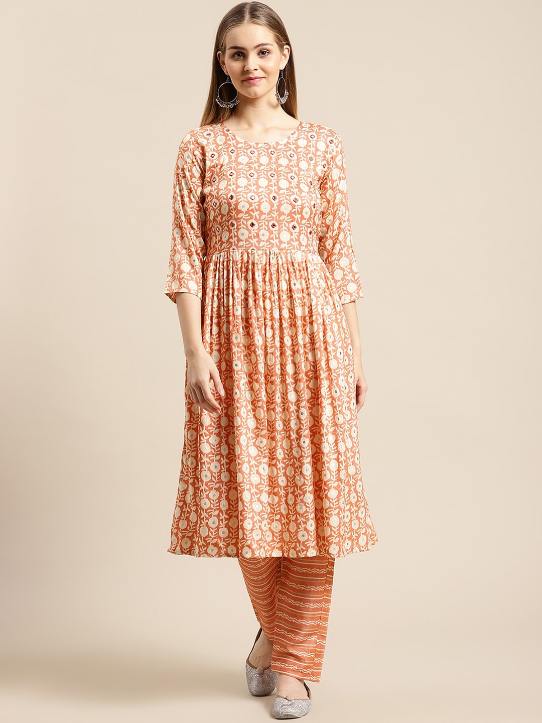 GUNVANTI FAB Women Orange Yoke Design Pleated Mirror Work Pure Cotton Kurta with Trousers
GUNVANTI FAB Women Orange Yoke Design Pleated Mirror Work Pure Cotton Kurta with Trousers