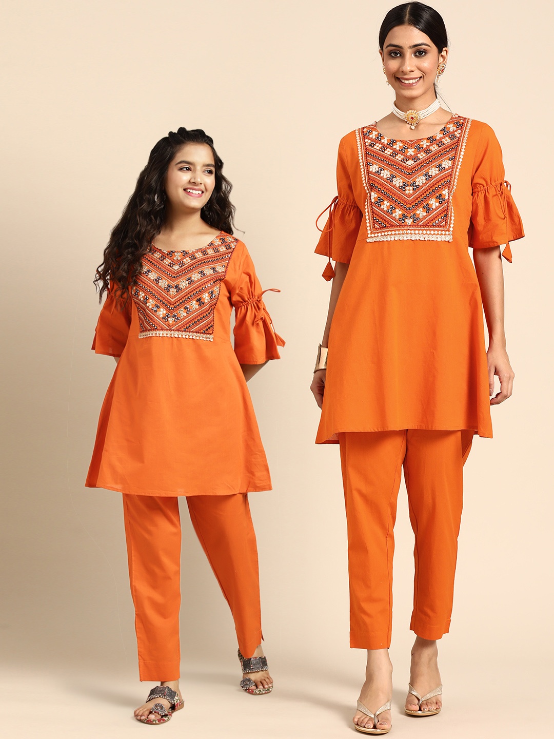 Sangria Teen Girls Yoke Design Mirror Work Pure Cotton Kurta with Trousers, Orange
Sangria Teen Girls Yoke Design Mirror Work Pure Cotton Kurta with Trousers, Orange