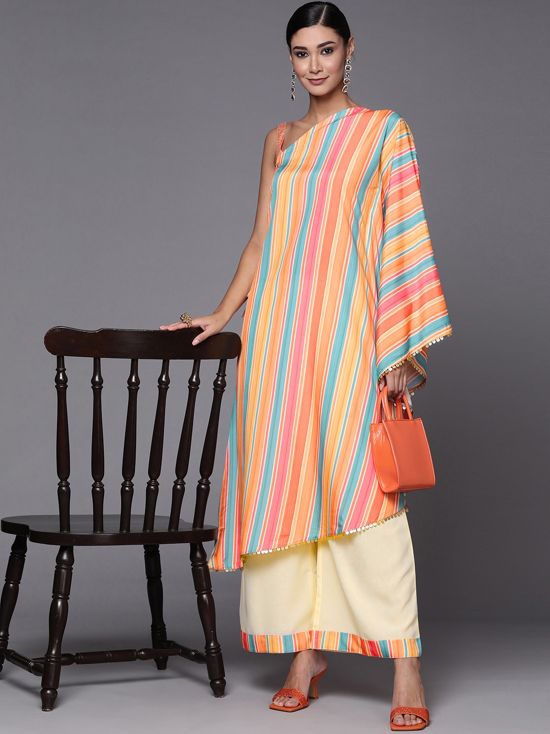Ahalyaa Peach-Coloured & Blue Printed Striped Asymmetric Taselled Kaftan Kurta Palazzos
Ahalyaa Peach-Coloured & Blue Printed Striped Asymmetric Taselled Kaftan Kurta Palazzos