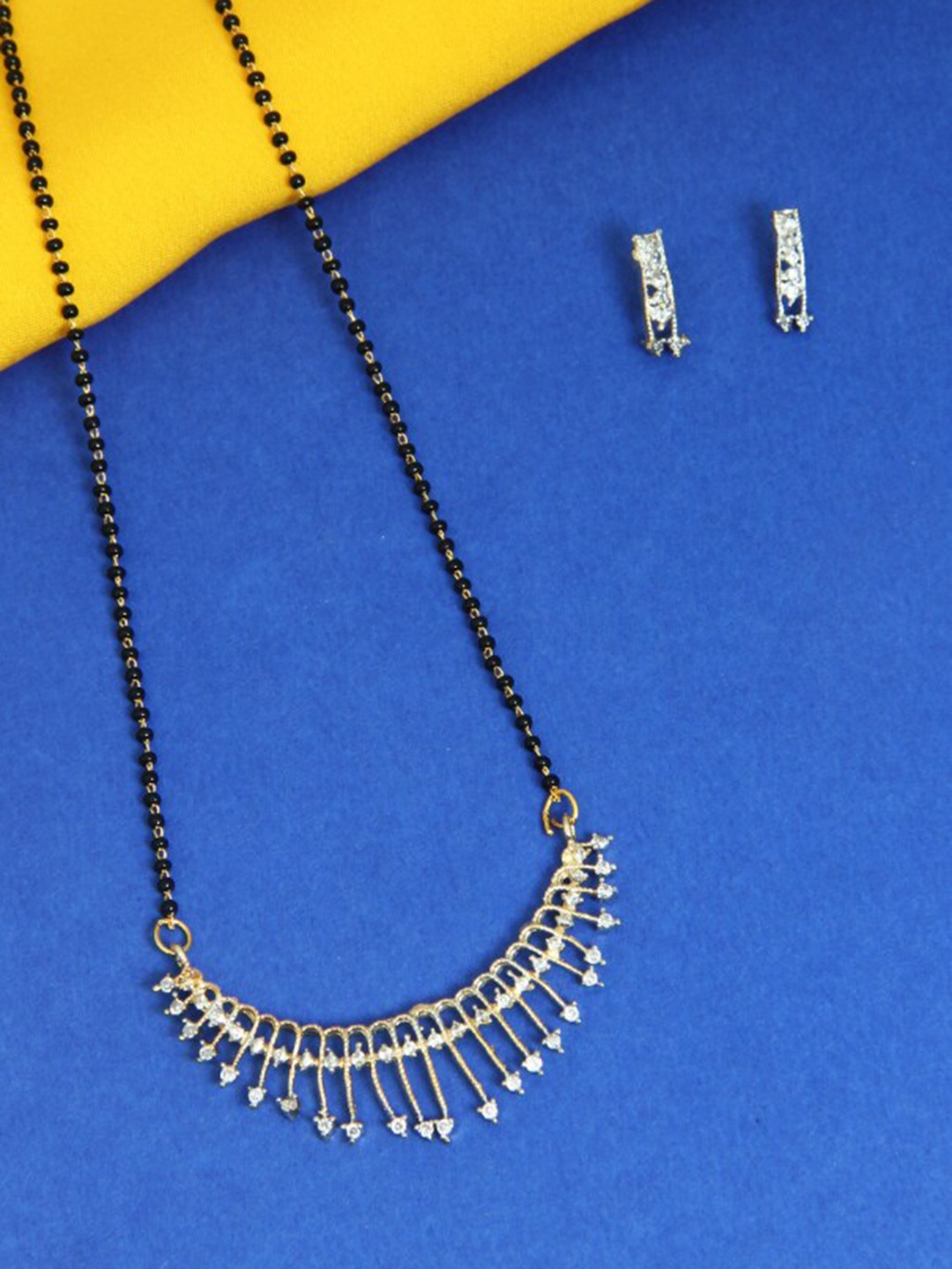 FEMMIBELLA Gold-Plated Black & White Stone-Studded & Beaded Mangalsutra With Earrings
FEMMIBELLA Gold-Plated Black & White Stone-Studded & Beaded Mangalsutra With Earrings