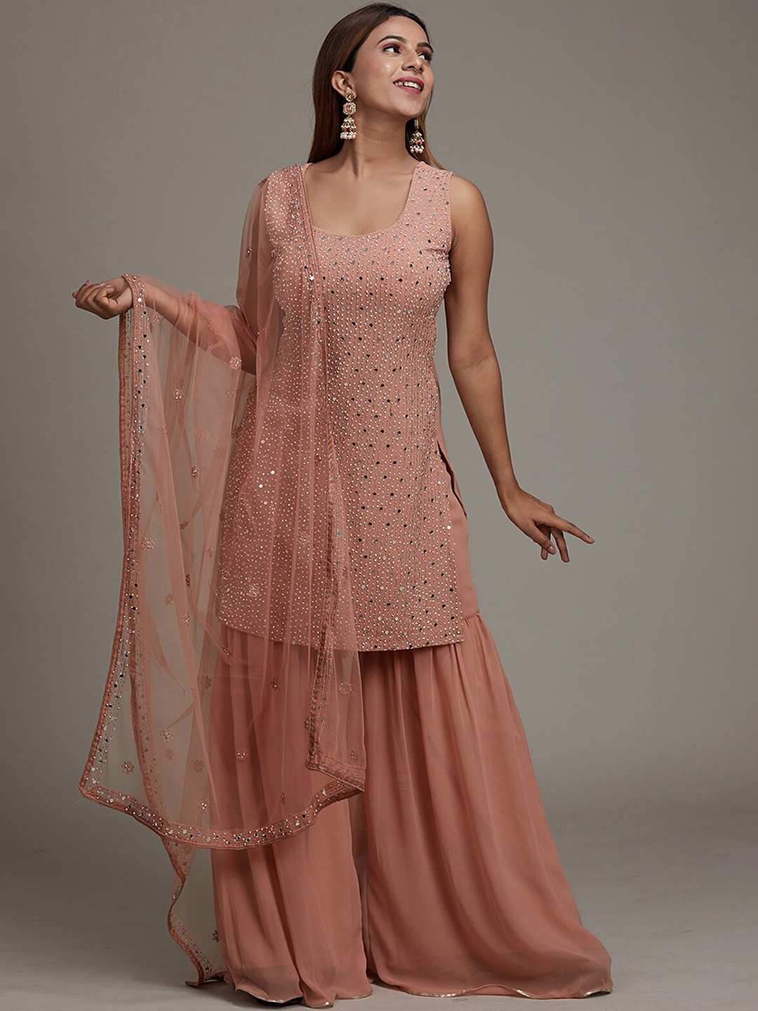Koskii Women Peach & Gold Embroidered Mirror Work Kurta with Sharara & With Dupatta
Koskii Women Peach & Gold Embroidered Mirror Work Kurta with Sharara & With Dupatta
