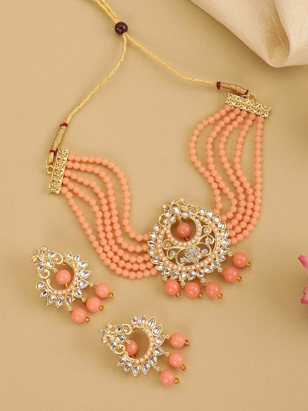 ZaffreCollections Women Gold-Plated Peach & White Crystal-Studded & Beaded Jewellery Set
ZaffreCollections Women Gold-Plated Peach & White Crystal-Studded & Beaded Jewellery Set