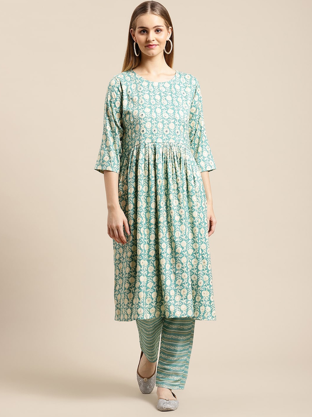 GUNVANTI FAB Women Blue Floral Printed Pleated Mirror Work Pure Cotton Kurta with Trousers
GUNVANTI FAB Women Blue Floral Printed Pleated Mirror Work Pure Cotton Kurta with Trousers