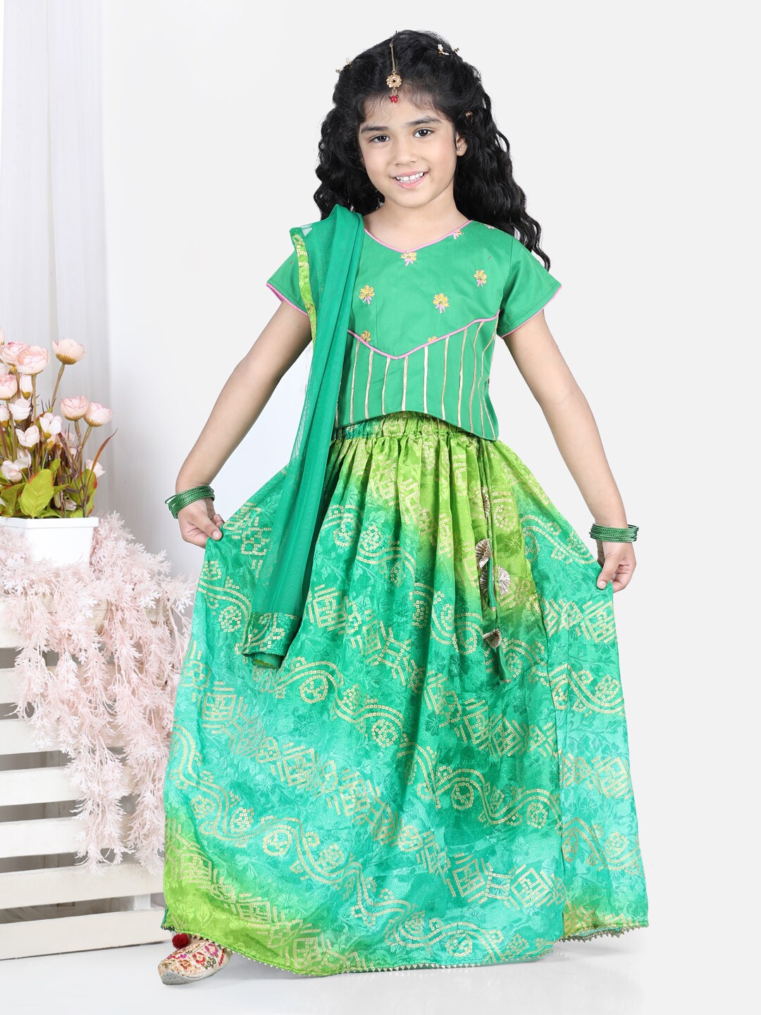 Here&Now X Kinder Kids Girls Green Lehriya Printed Lehenga with Lace and Embroidered Top and Dupatta
Here&Now X Kinder Kids Girls Green Lehriya Printed Lehenga with Lace and Embroidered Top and Dupatta