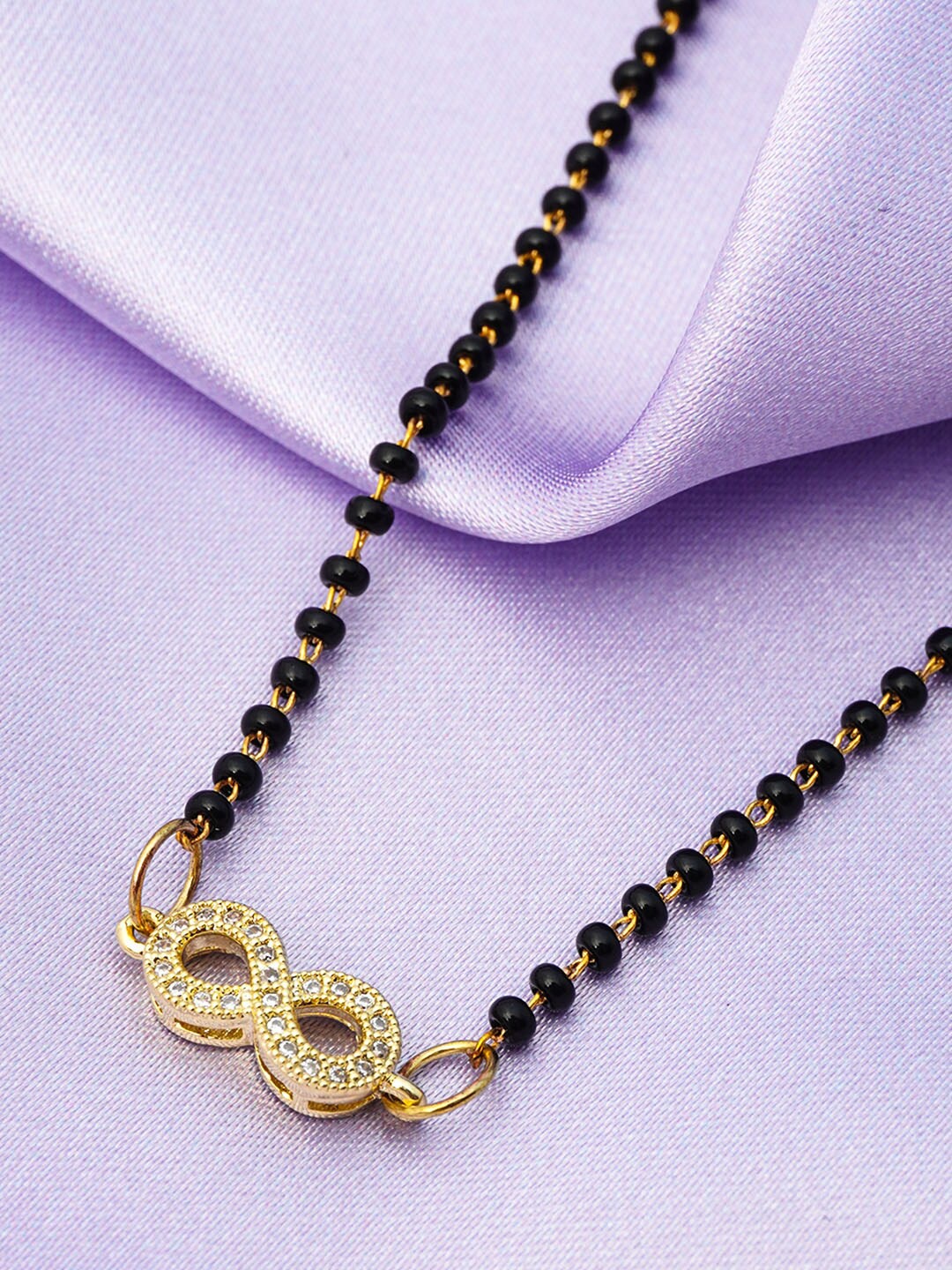 Ferosh Black And Gold Toned Gold Plated Infinity Pendant Stone-Studded Beaded Mangalsutra
Ferosh Black And Gold Toned Gold Plated Infinity Pendant Stone-Studded Beaded Mangalsutra