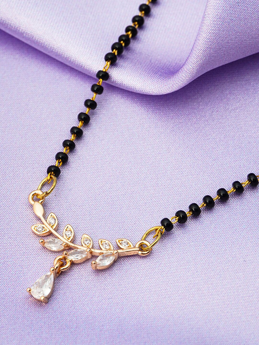 Ferosh Black And Gold Toned Gold-Plated Crystal Leaf Vine Pendant Beaded Mangalsutra
Ferosh Black And Gold Toned Gold-Plated Crystal Leaf Vine Pendant Beaded Mangalsutra