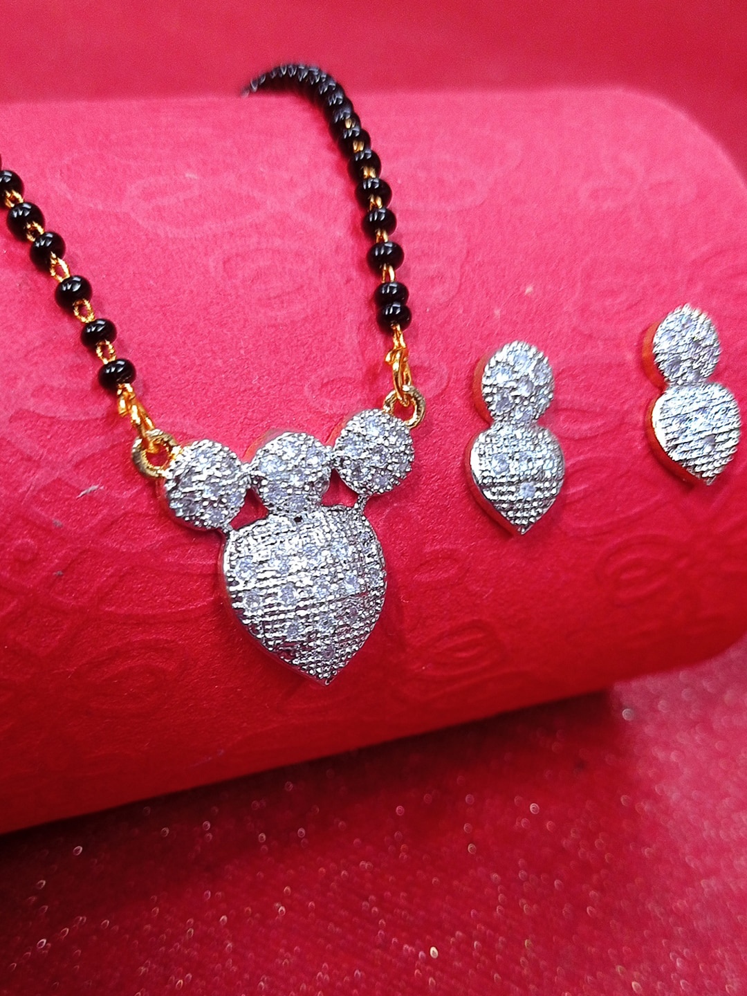 OOMPH Women Silver Toned & Black American Diamond Heart Love Mangalsurta & Earrings Set
OOMPH Women Silver Toned & Black American Diamond Heart Love Mangalsurta & Earrings Set