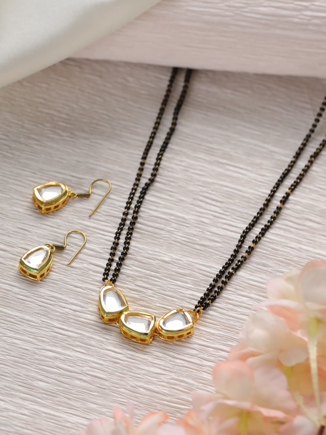 Jazz and Sizzle White & Black Gold-Plated Kundan-Studded Mangalsutra With Earrings
Jazz and Sizzle White & Black Gold-Plated Kundan-Studded Mangalsutra With Earrings