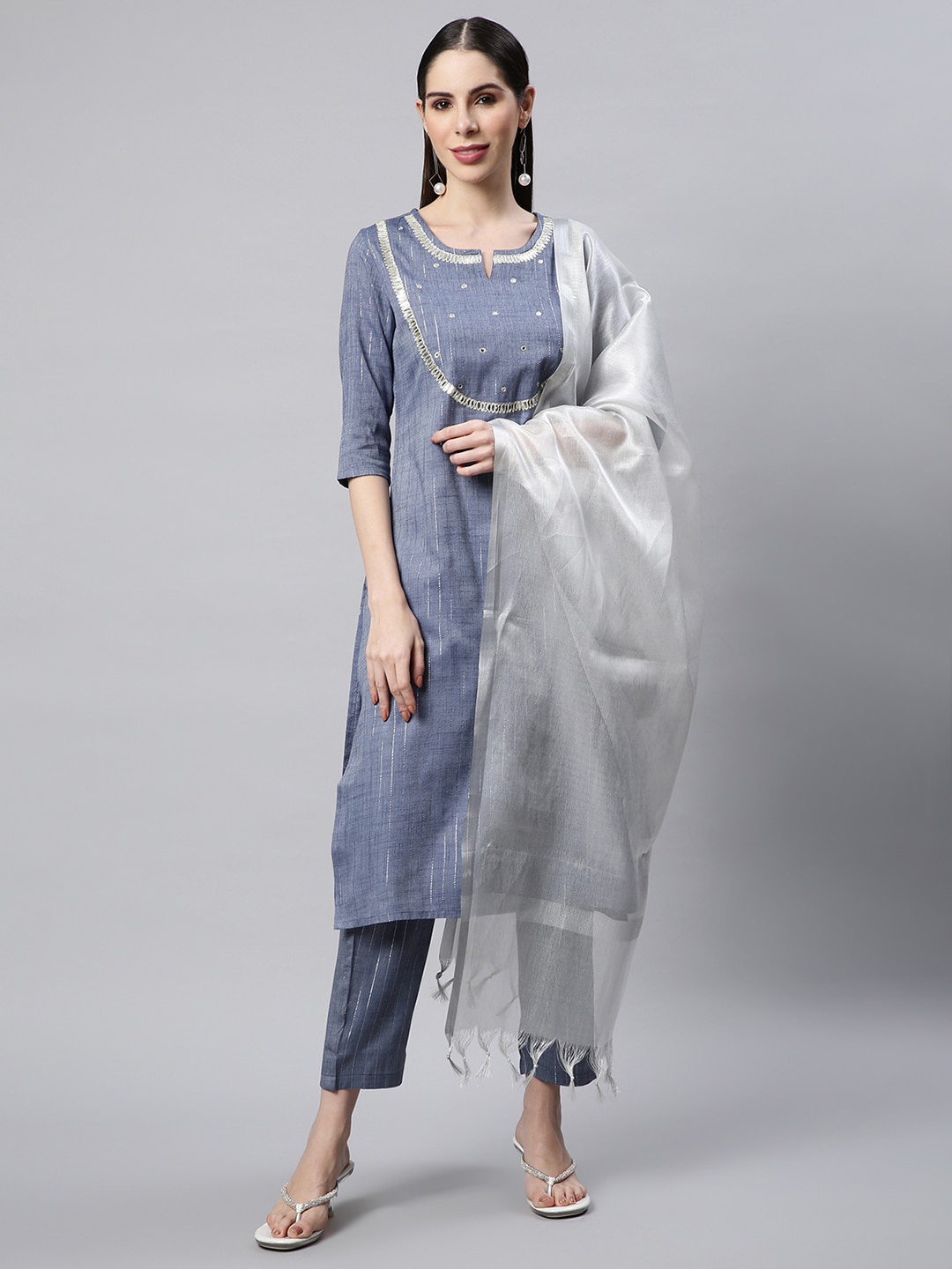 Sringam Women Grey & Silver Embroidered Mirror Work Kurta with Trousers & With Dupatta
Sringam Women Grey & Silver Embroidered Mirror Work Kurta with Trousers & With Dupatta