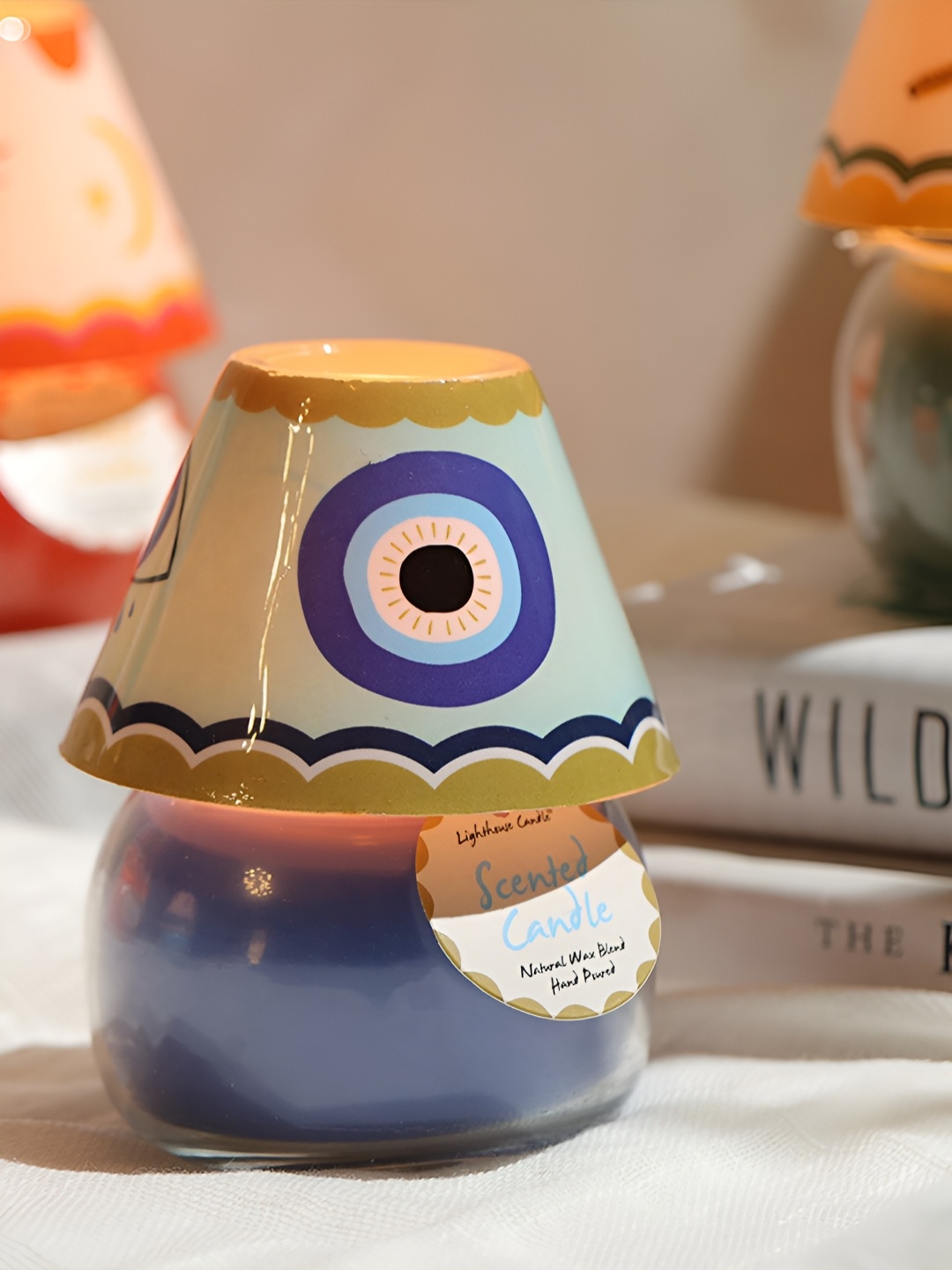 LIGHTHOUSE CANDLE Blue & White Evil Eye Printed Madurai Jasmine Scented Glass Lamp Candle
LIGHTHOUSE CANDLE Blue & White Evil Eye Printed Madurai Jasmine Scented Glass Lamp Candle
