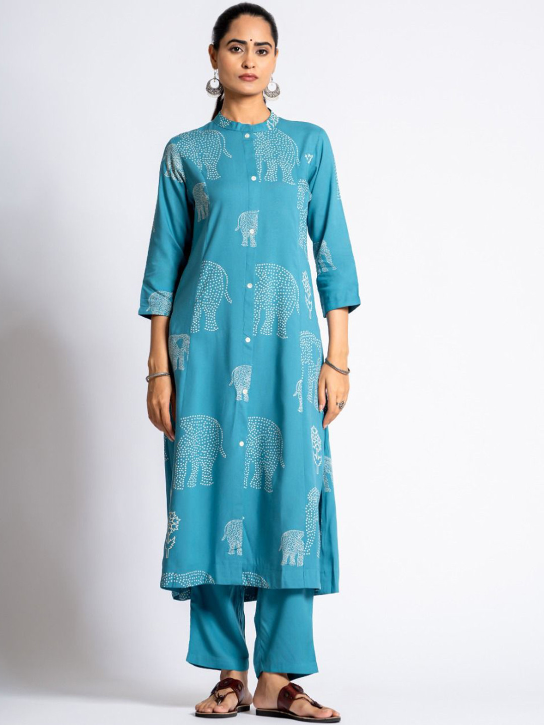 KALINI Ethnic Motifs Printed Mandarin Collar A-Line Kurta With Trousers, Turquoise blue
KALINI Ethnic Motifs Printed Mandarin Collar A-Line Kurta With Trousers, Turquoise blue