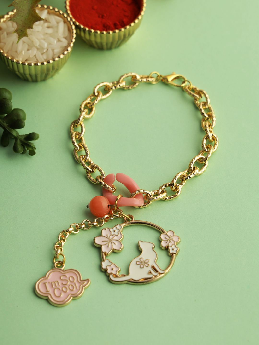 Kook N Keech Gold Toned Charm Bracelet Wraparound Rakhi with Roli Chawal & Greetings Card
Kook N Keech Gold Toned Charm Bracelet Wraparound Rakhi with Roli Chawal & Greetings Card