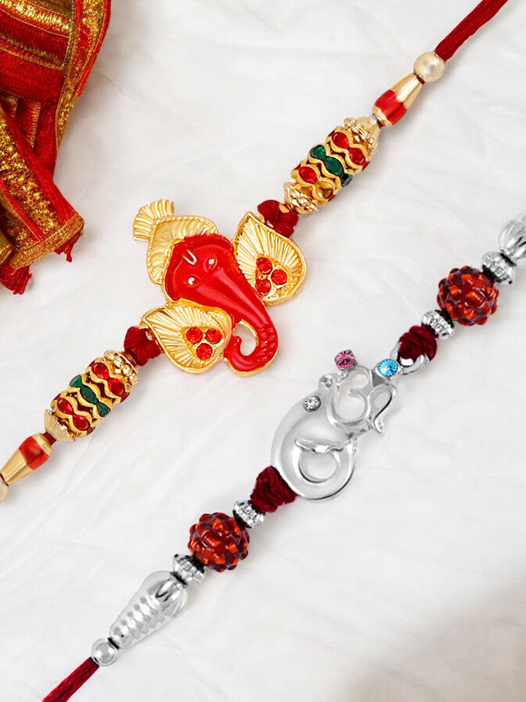 Okos Set of 2 Gold Plated Siddhivinayaka Inspired Ganesha With Sided Faced And Om Rakhis, Red
Okos Set of 2 Gold Plated Siddhivinayaka Inspired Ganesha With Sided Faced And Om Rakhis, Red