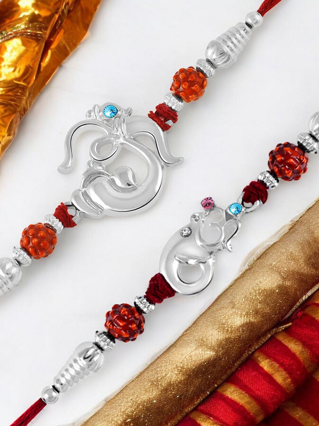 Okos Set Of 2 Rhodium Plated Auspisious Religious Om and Ganesha Thread Rakhis, Silver
Okos Set Of 2 Rhodium Plated Auspisious Religious Om and Ganesha Thread Rakhis, Silver
