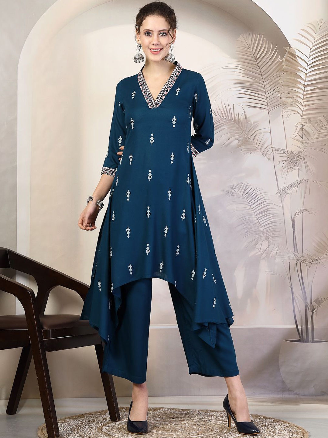 KIMAYRA V-Neck Ethnic Motifs Woven Design Thread Work Asymmetric A-Line Kurta with Palazzo, Blue
KIMAYRA V-Neck Ethnic Motifs Woven Design Thread Work Asymmetric A-Line Kurta with Palazzo, Blue
