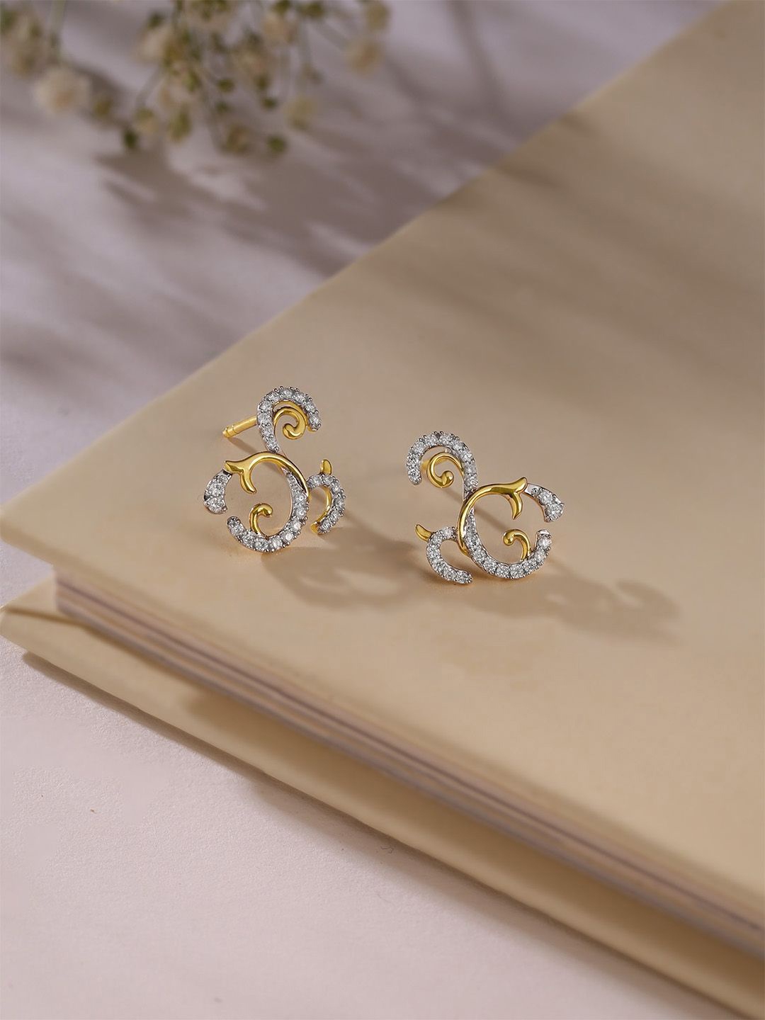 Mia by Tanishq Women 14KT Floral Swirl Gold & Diamond Stud Earrings - 1.889 gm, Yellow
Mia by Tanishq Women 14KT Floral Swirl Gold & Diamond Stud Earrings - 1.889 gm, Yellow