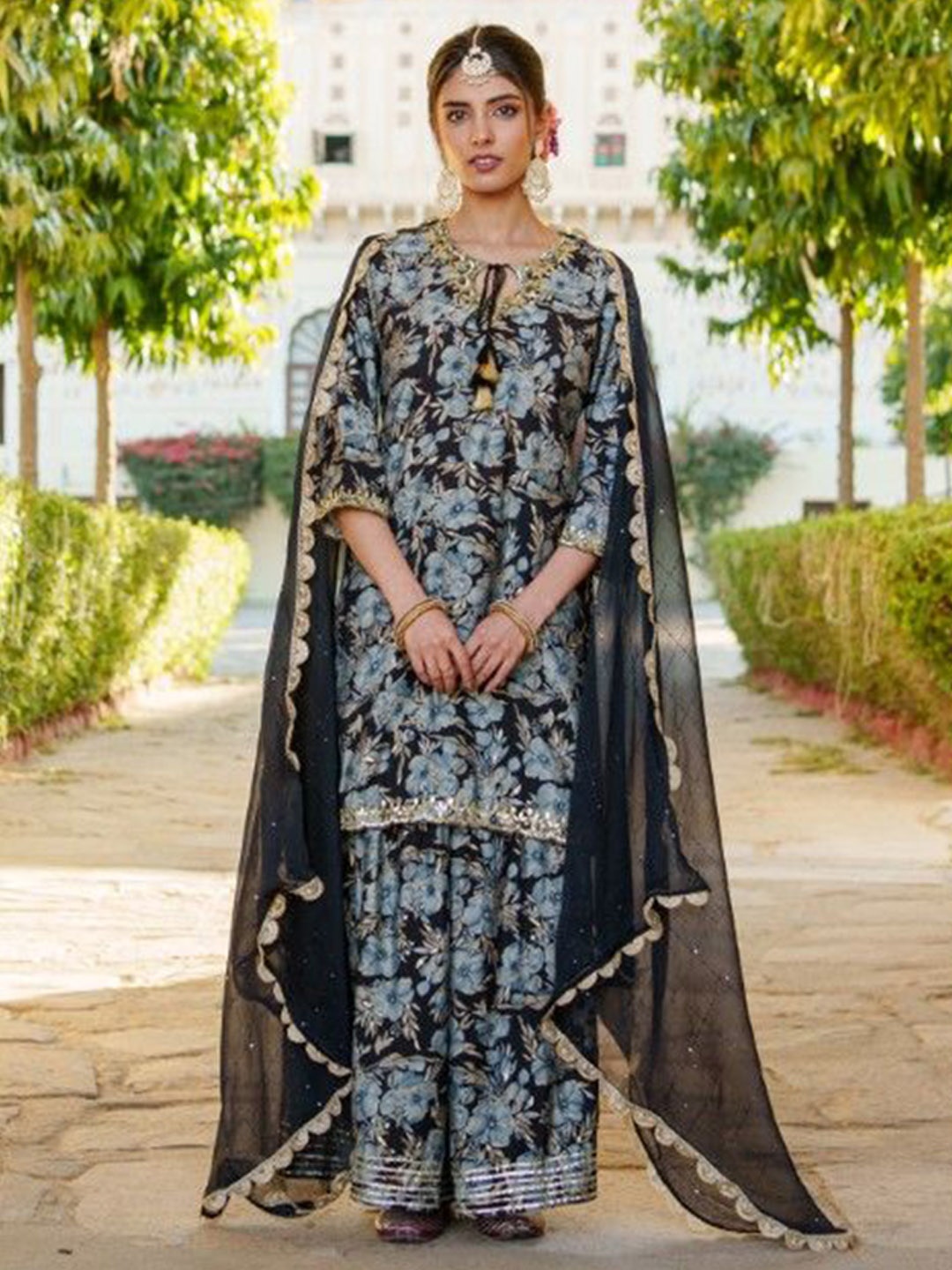 VAASVA JAIPUR Floral Printed Tie-Up Neck Gotta Patti Straight Kurta & Sharara With Dupatta, Navy blue
VAASVA JAIPUR Floral Printed Tie-Up Neck Gotta Patti Straight Kurta & Sharara With Dupatta, Navy blue