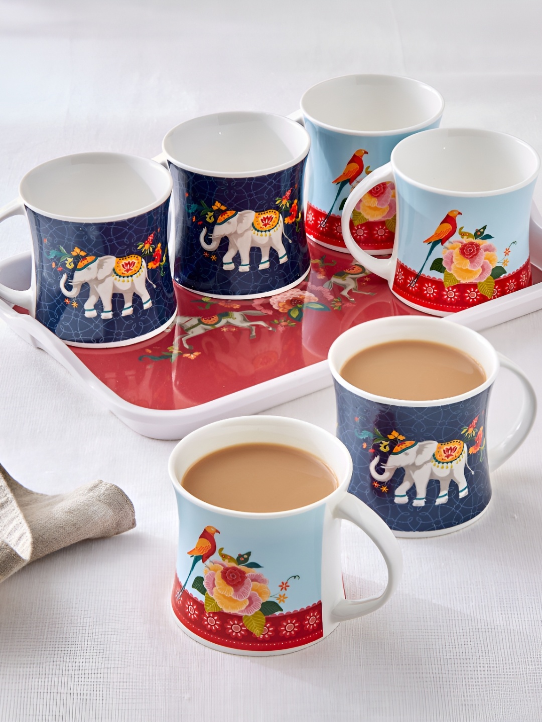 Home Centre Jalsa Blue & Red 7 Pieces Ethnic Printed Glossy Mugs with Tray 200ml
Home Centre Jalsa Blue & Red 7 Pieces Ethnic Printed Glossy Mugs with Tray 200ml