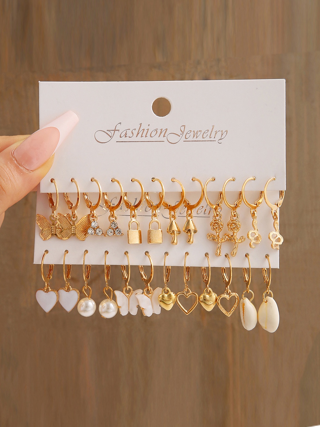 Shining Diva Fashion Pack Of 12 Gold-Plated Artificial Stones and Beads Hoop Earrings
Shining Diva Fashion Pack Of 12 Gold-Plated Artificial Stones and Beads Hoop Earrings