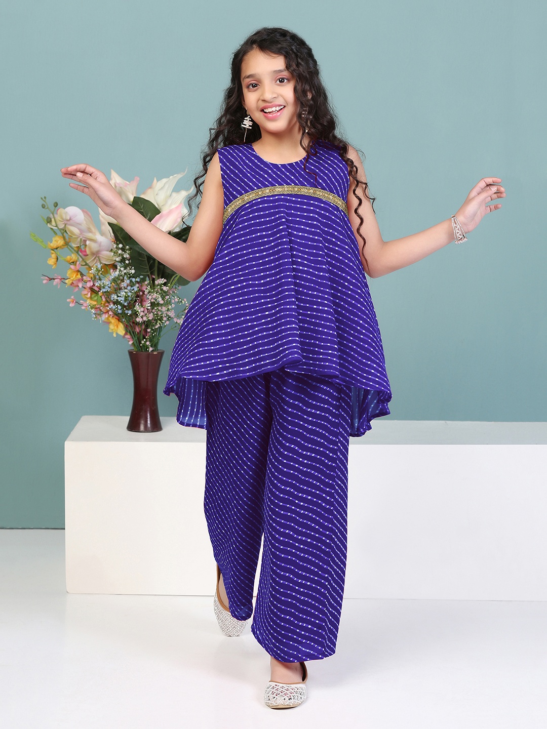 Sangria Girls Blue Leheriya Printed Empire Sleeveless Georgette A-Line Kurta With Palazzos
Sangria Girls Blue Leheriya Printed Empire Sleeveless Georgette A-Line Kurta With Palazzos