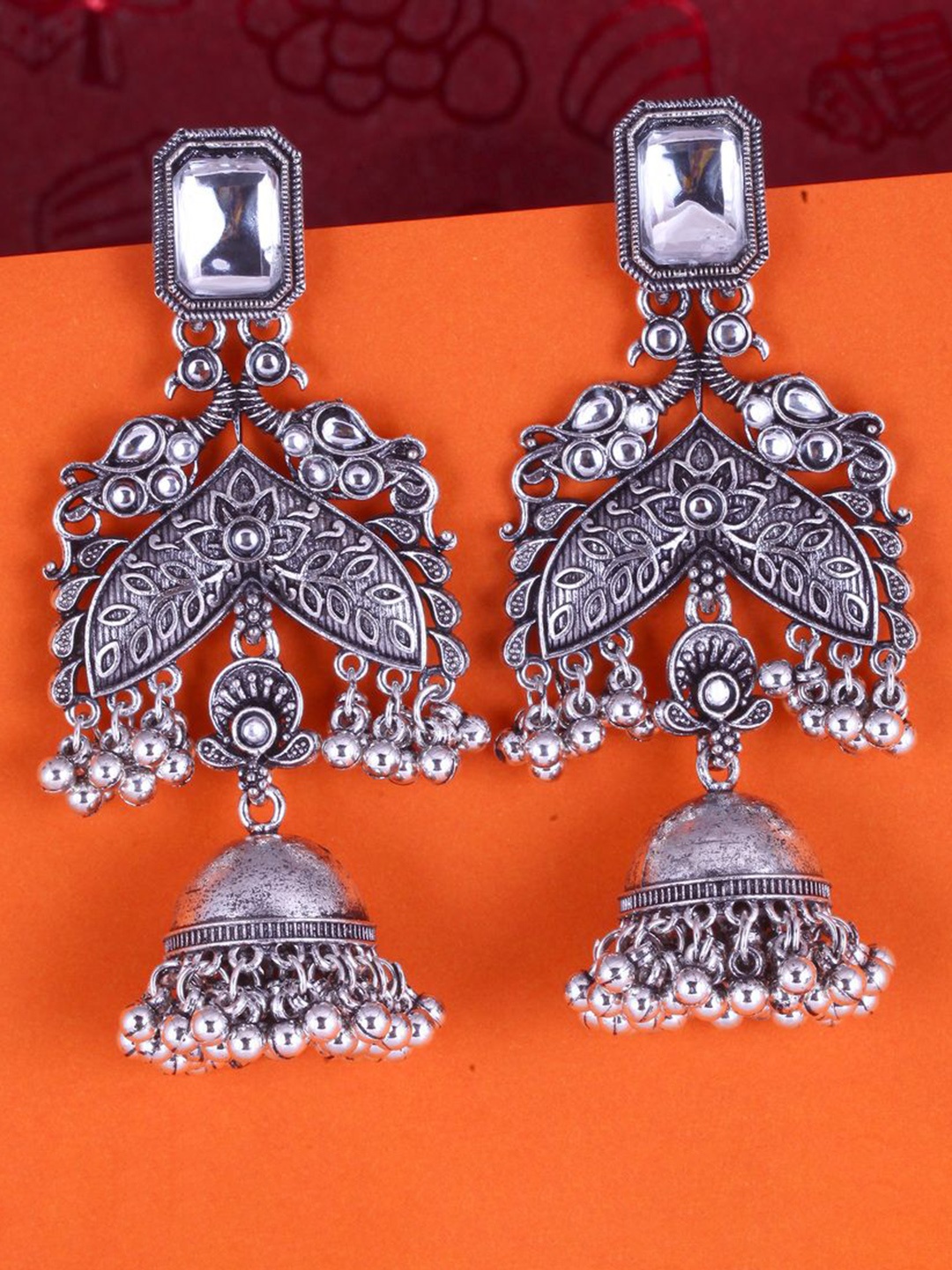 DIVASTRI Silver-Plated Pearls Beaded & Kundan Studded Peacock Shaped Oxidised Jhumkas
DIVASTRI Silver-Plated Pearls Beaded & Kundan Studded Peacock Shaped Oxidised Jhumkas