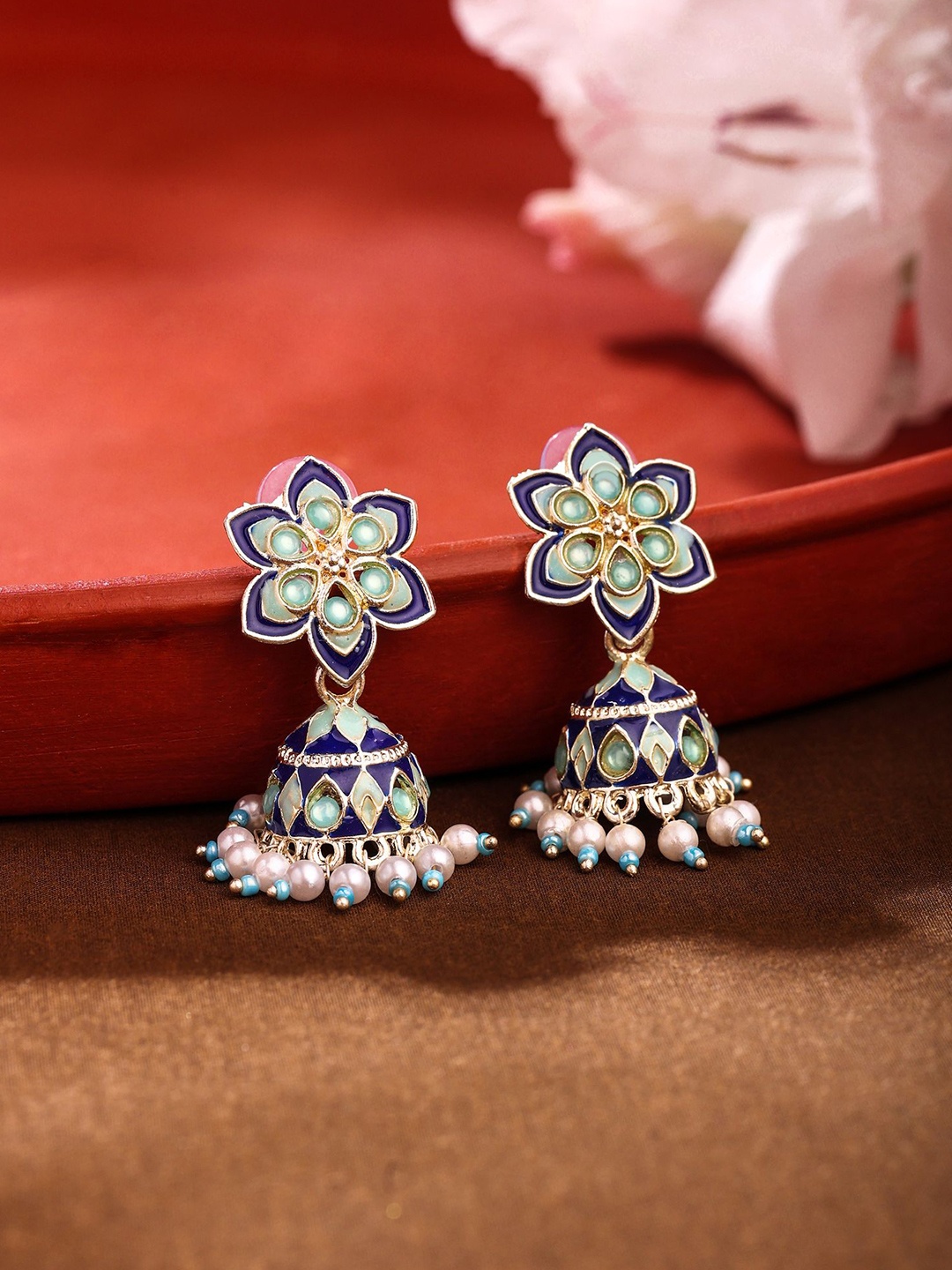 Yellow Chimes Gold-Plated Dome Shaped Artificial Stones and Beads Jhumkas Earrings, Blue
Yellow Chimes Gold-Plated Dome Shaped Artificial Stones and Beads Jhumkas Earrings, Blue