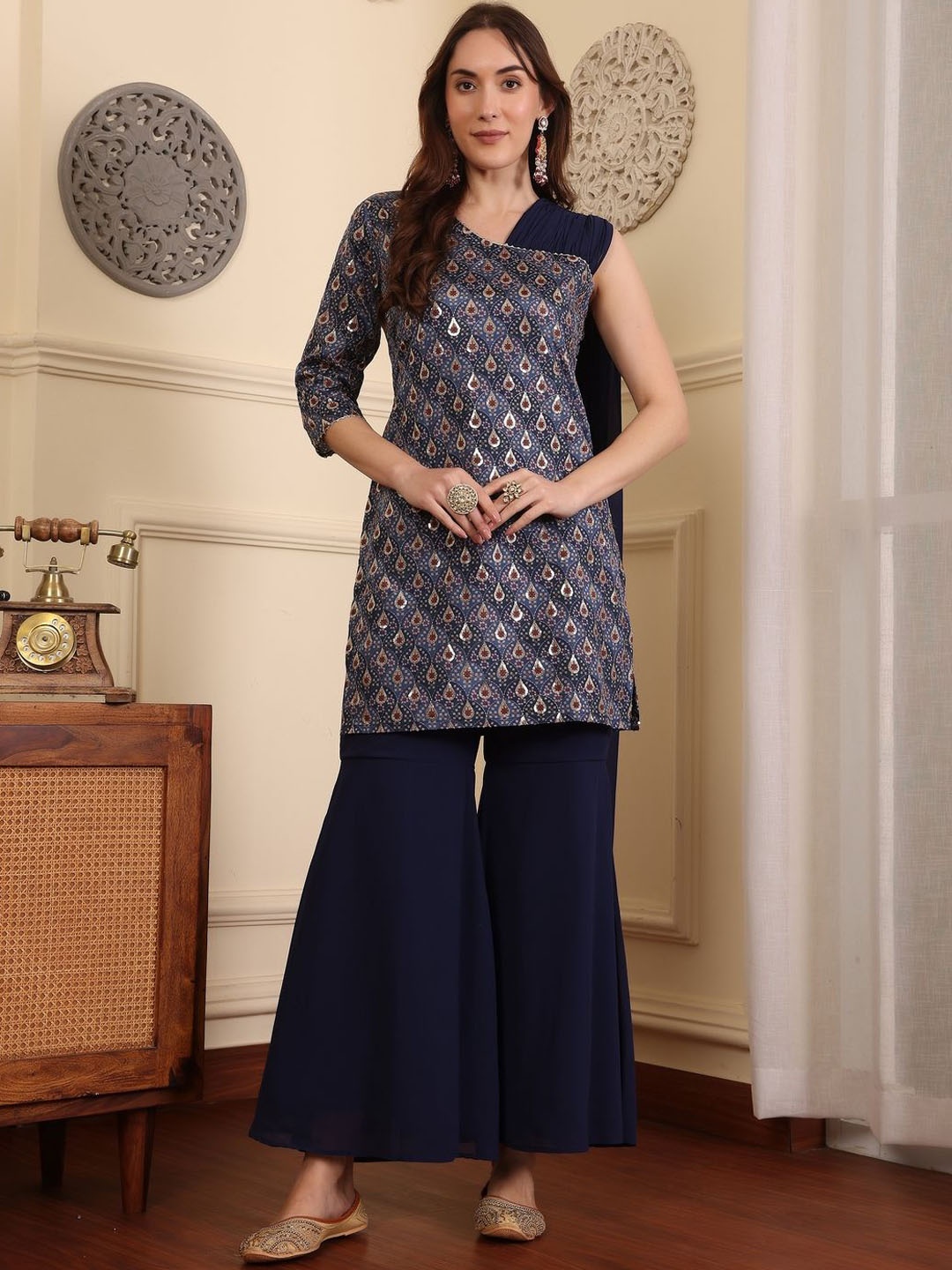 ADORNIA Ethnic Motifs Printed Asysmmetric Neck Sequinned Straight Kurta With Sharara, Navy blue
ADORNIA Ethnic Motifs Printed Asysmmetric Neck Sequinned Straight Kurta With Sharara, Navy blue