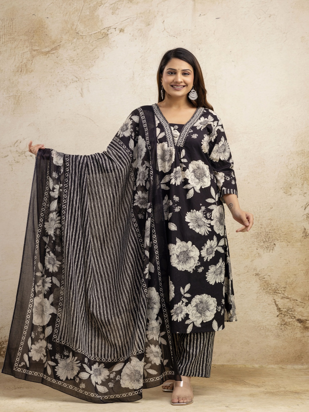 NISHIRE Floral Printed V-Neck Pleated Pure Cotton A-Line Kurta With Trouser & Dupatta, Black
NISHIRE Floral Printed V-Neck Pleated Pure Cotton A-Line Kurta With Trouser & Dupatta, Black