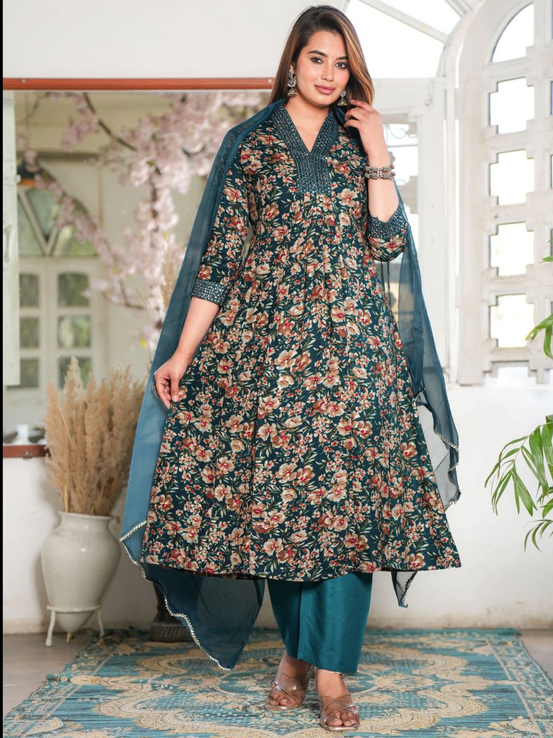 SINGNI Floral Printed Pleated Mirror Work Anarkali Kurta with Trouser & Dupatta, Teal
SINGNI Floral Printed Pleated Mirror Work Anarkali Kurta with Trouser & Dupatta, Teal