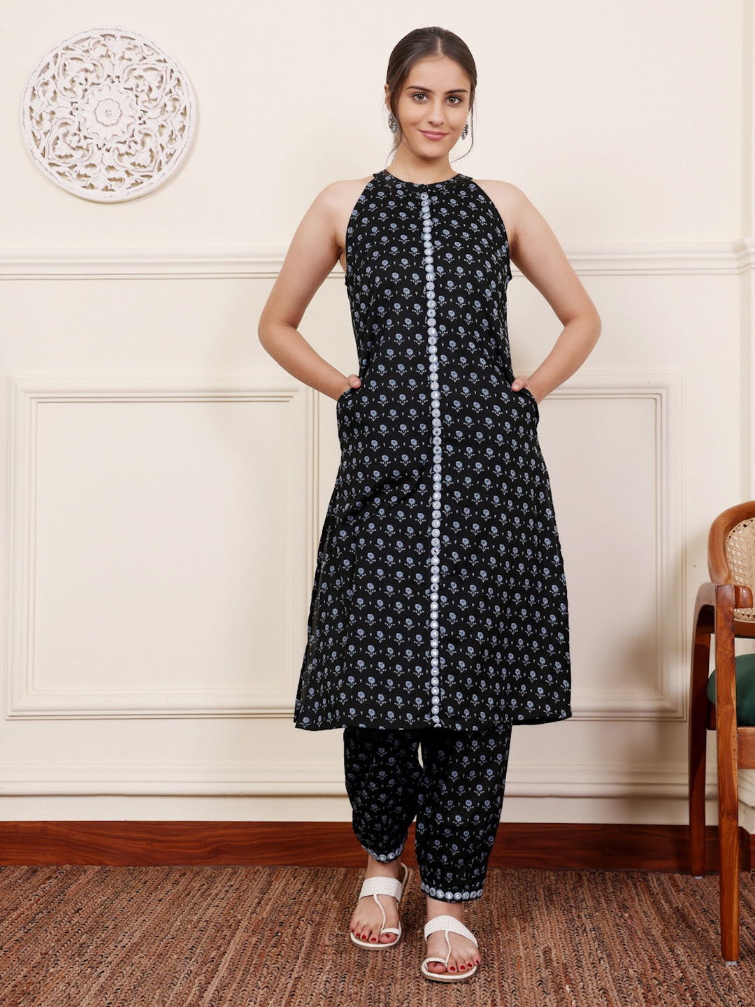 SAVI Floral Printed Halter Neck Mirror Work Pure Cotton Straight Kurta With Trouser, Black
SAVI Floral Printed Halter Neck Mirror Work Pure Cotton Straight Kurta With Trouser, Black