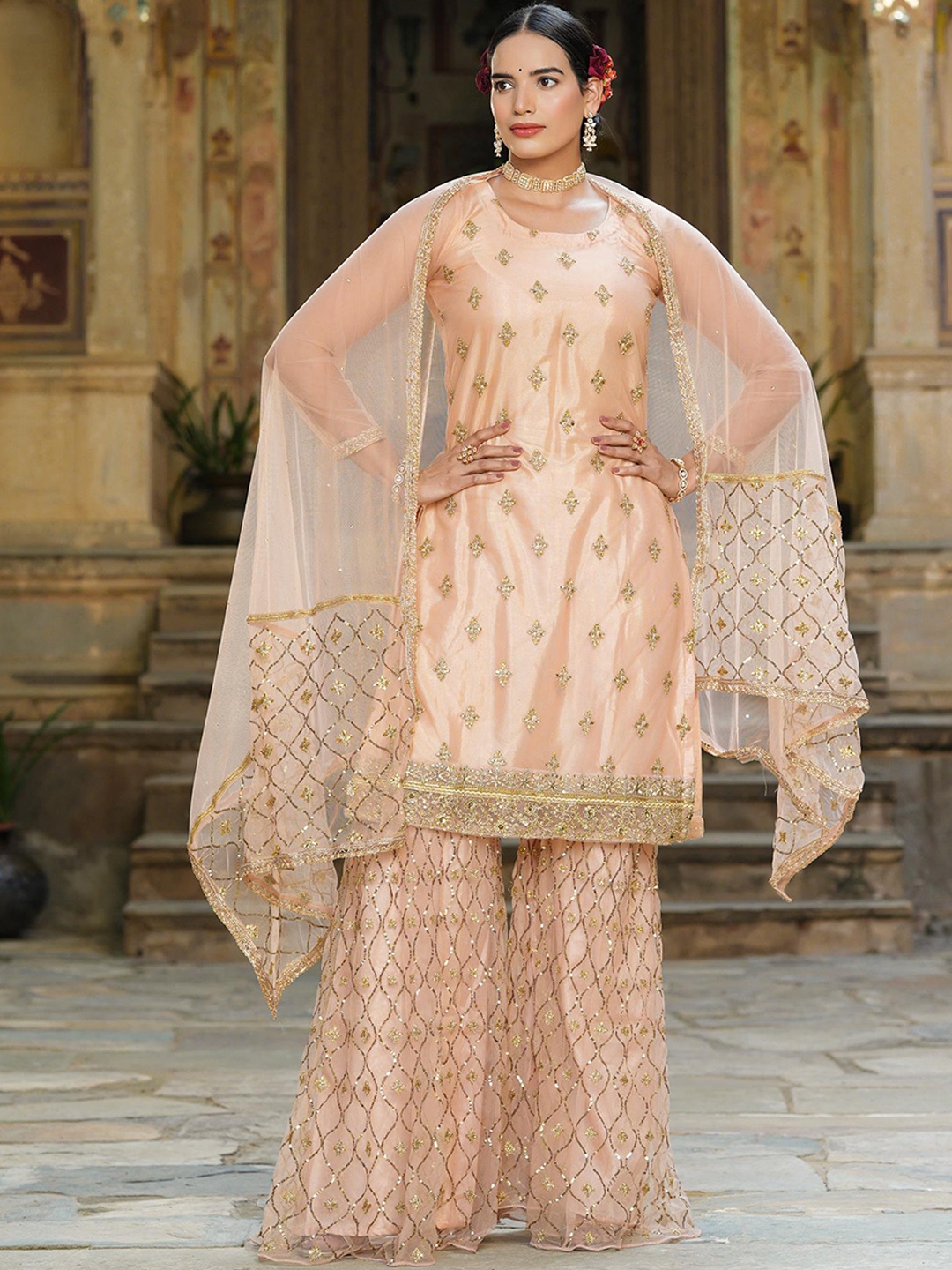 SCAKHI Women Peach-Coloured Ethnic Motifs Beads and Stones Kurta with Sharara & Dupatta
SCAKHI Women Peach-Coloured Ethnic Motifs Beads and Stones Kurta with Sharara & Dupatta