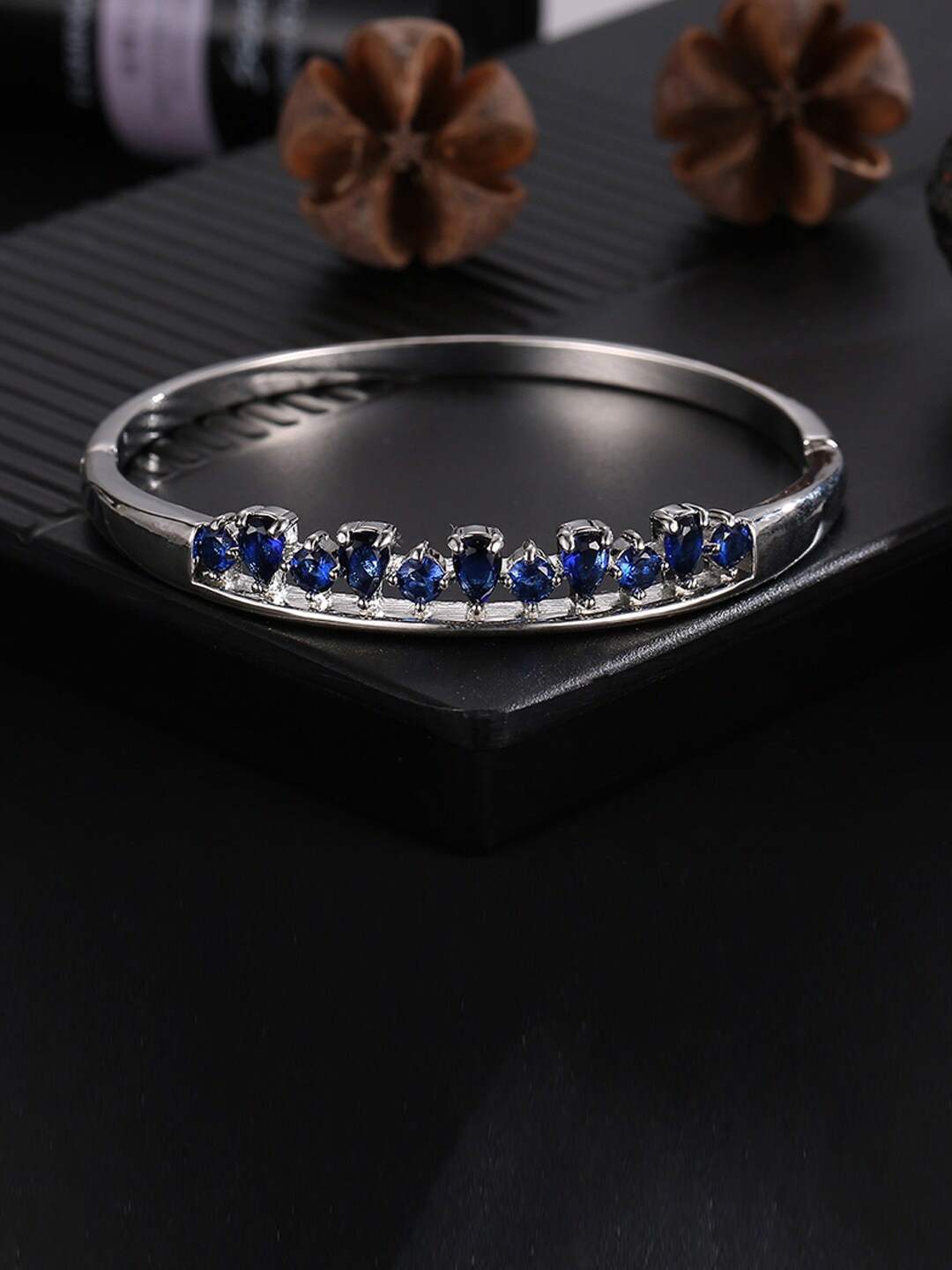 Designs By Jewels Galaxy Women Silver-Toned & Navy Blue Brass Cubic Zirconia Silver-Plated Bangle-Style Bracelet
Designs By Jewels Galaxy Women Silver-Toned & Navy Blue Brass Cubic Zirconia Silver-Plated Bangle-Style Bracelet