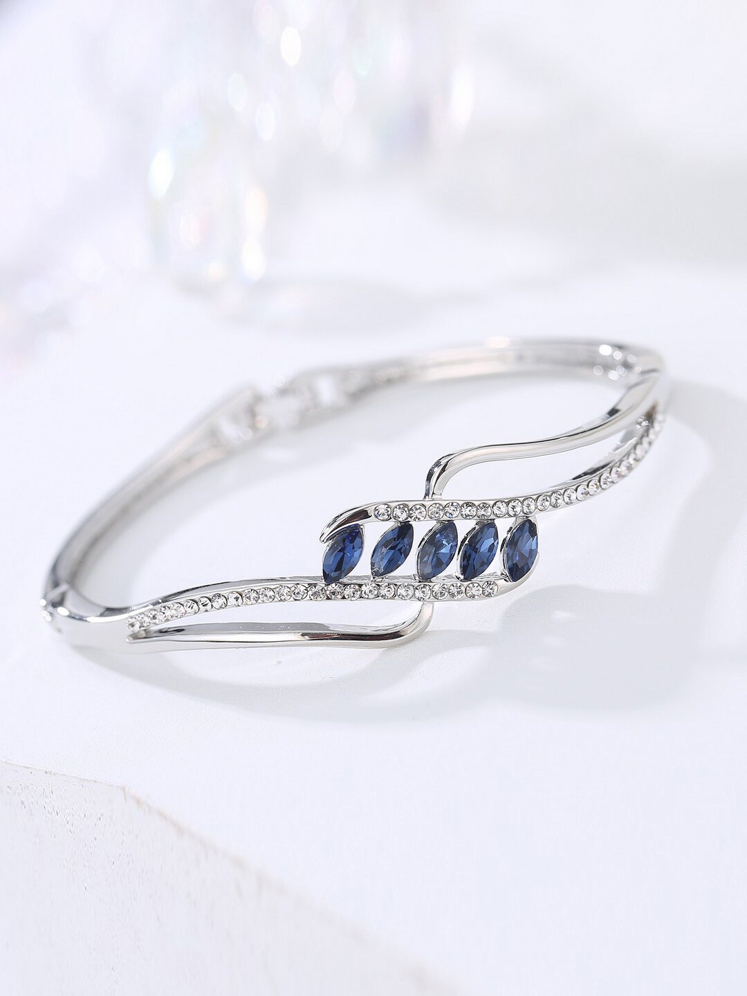 Designs By Jewels Galaxy Women Silver-Toned & Blue Brass American Diamond Silver-Plated Bangle-Style Bracelet
Designs By Jewels Galaxy Women Silver-Toned & Blue Brass American Diamond Silver-Plated Bangle-Style Bracelet