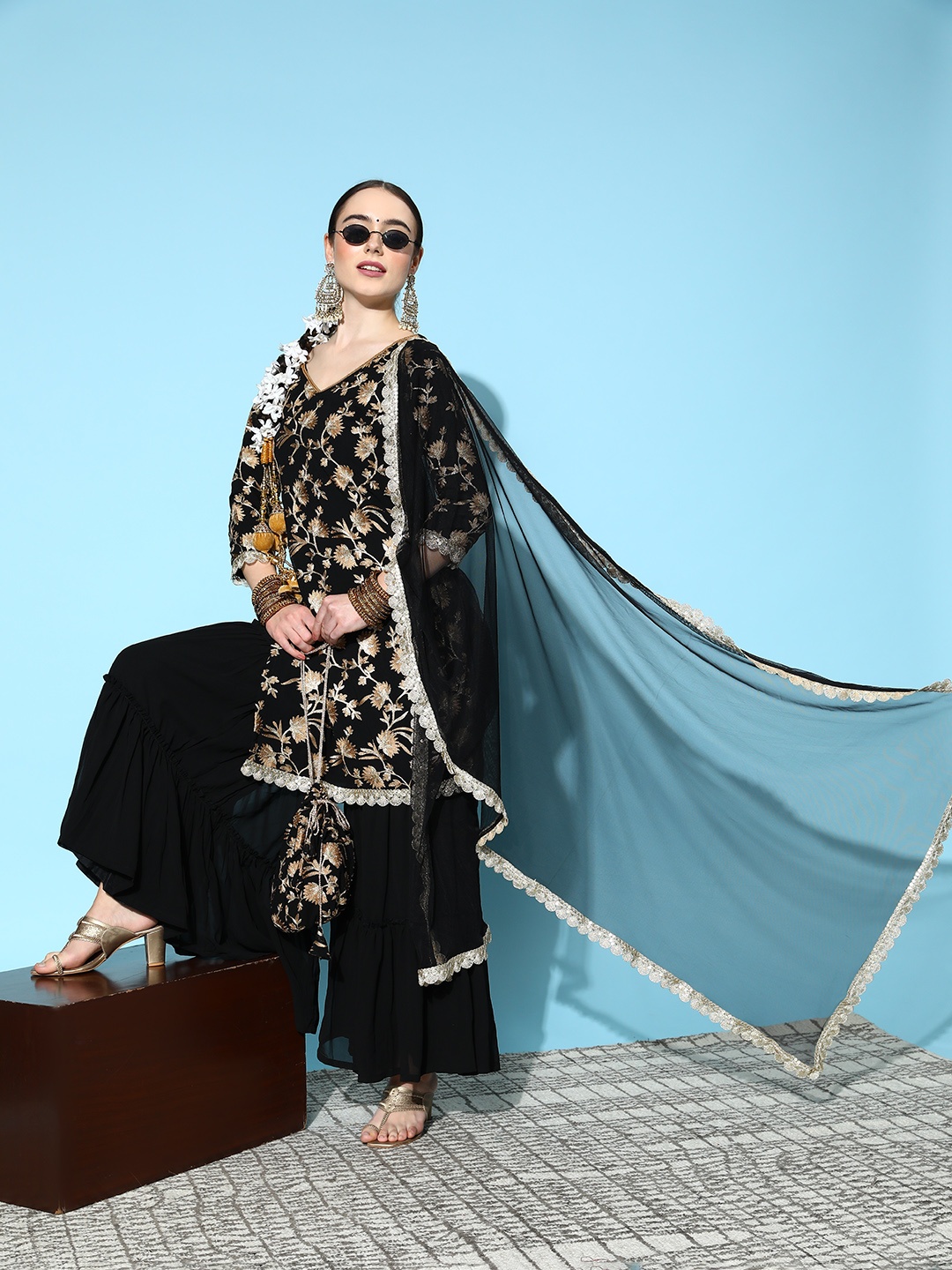 Libas Women Black Floral Embroidered Thread Work Kurta with Sharara & Dupatta & with Potli
Libas Women Black Floral Embroidered Thread Work Kurta with Sharara & Dupatta & with Potli