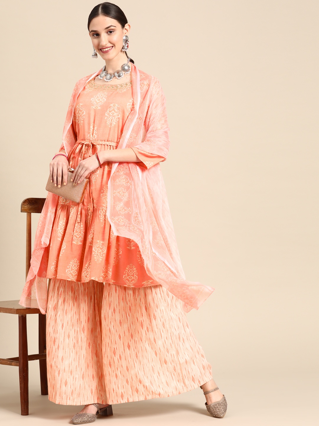 Sangria Women Peach-Coloured Ethnic Motifs Printed Sequinned Kurta with Sharara & With Dupatta
Sangria Women Peach-Coloured Ethnic Motifs Printed Sequinned Kurta with Sharara & With Dupatta