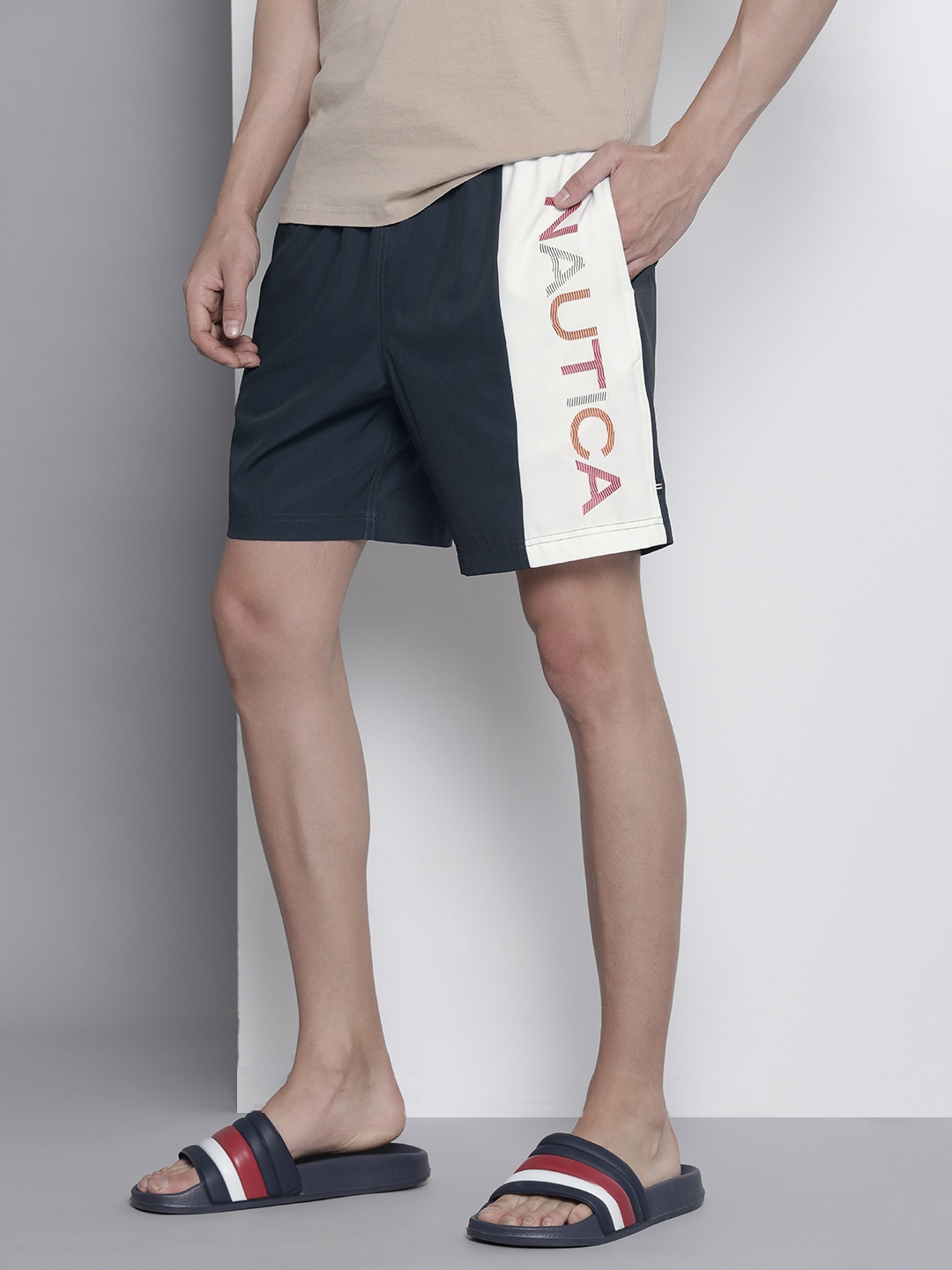 Nautica Men Brand Logo Printed Side Striped Detailed Mid Rise Swim Shorts, Navy blue
Nautica Men Brand Logo Printed Side Striped Detailed Mid Rise Swim Shorts, Navy blue