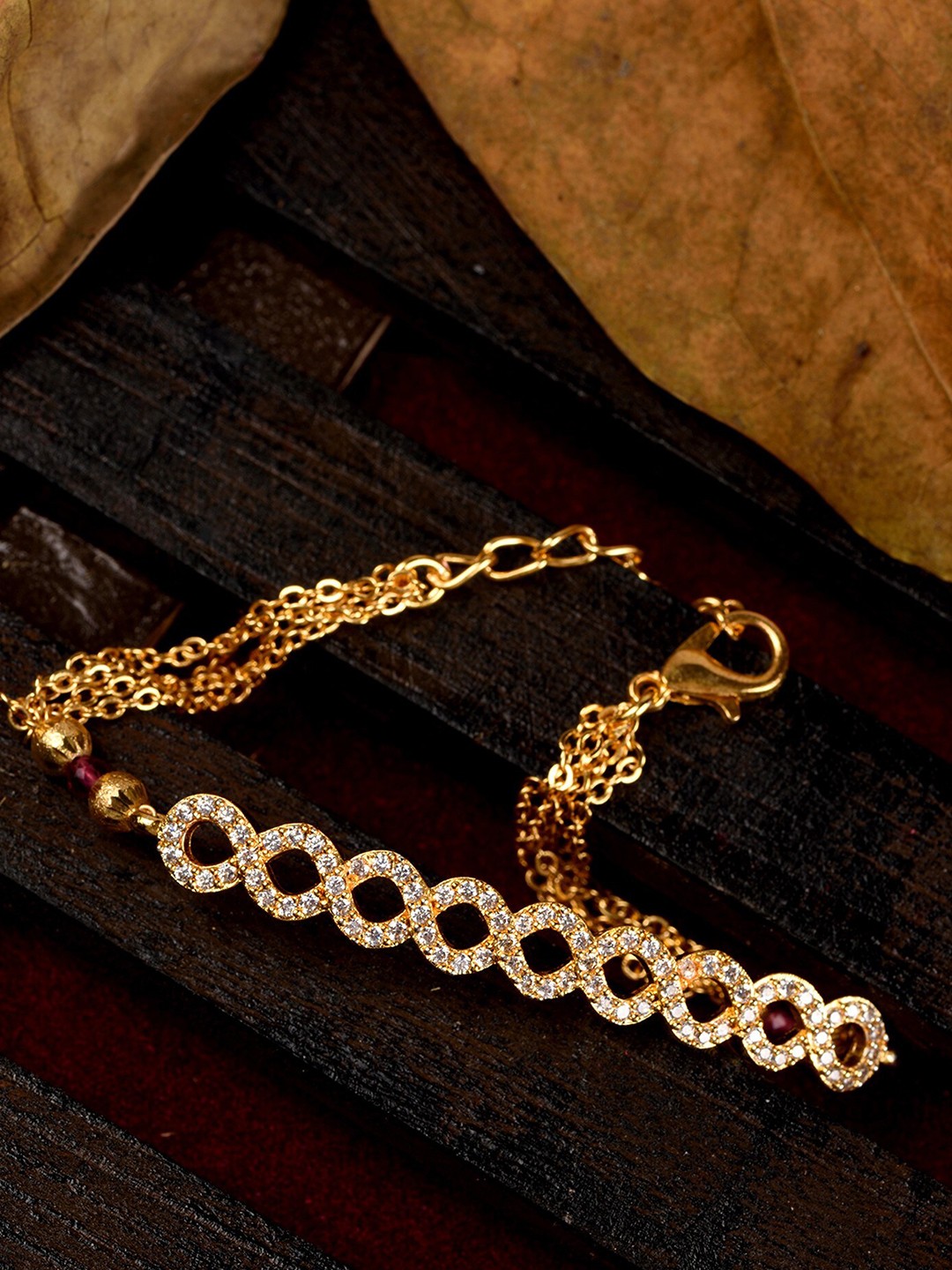 Saraf RS Jewellery Women Gold-Toned & White Brass American Diamond Gold-Plated Link Bracelet
Saraf RS Jewellery Women Gold-Toned & White Brass American Diamond Gold-Plated Link Bracelet