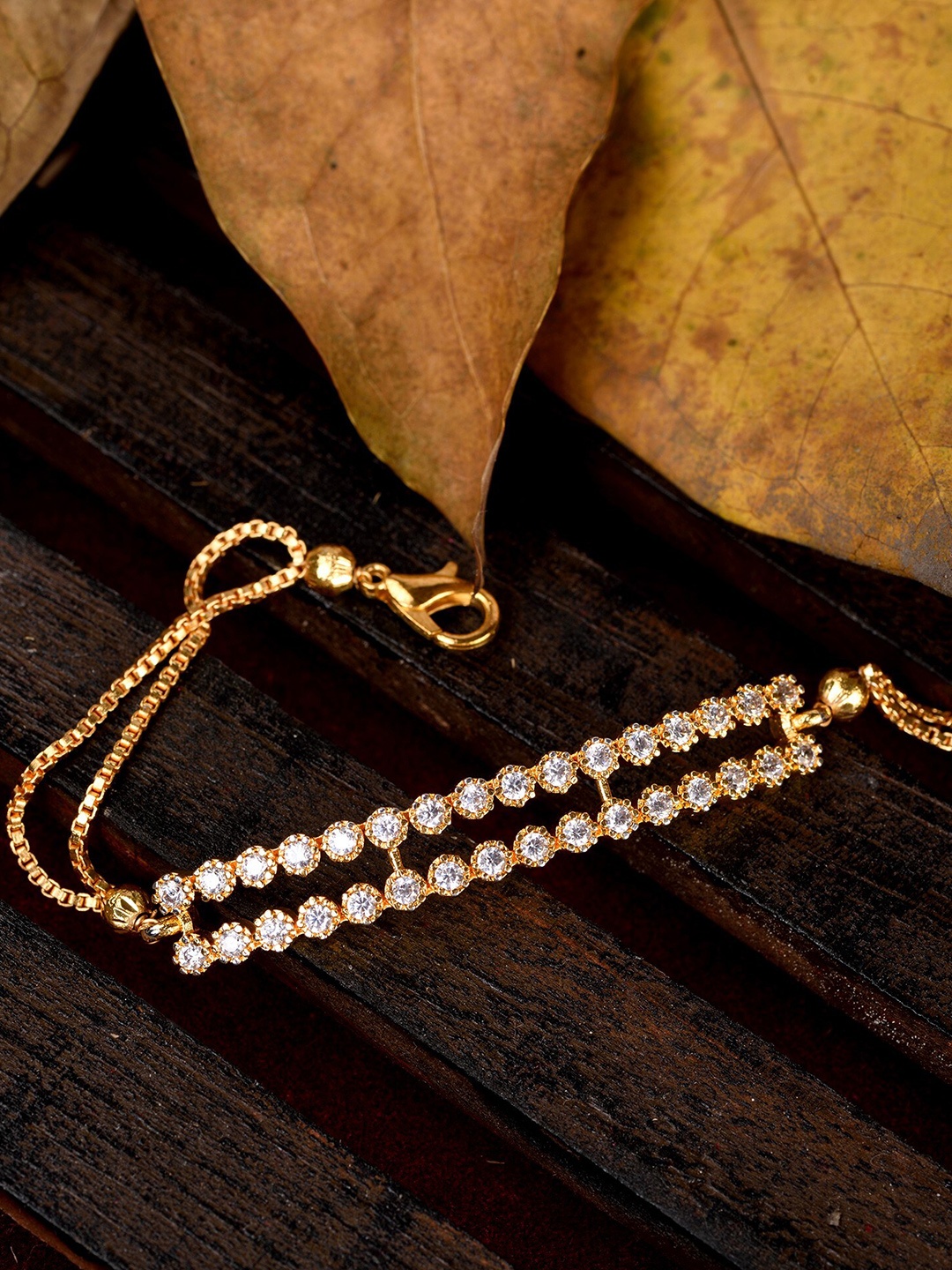 Saraf RS Jewellery Women Gold-Toned & White Brass American Diamond Gold-Plated Charm Bracelet
Saraf RS Jewellery Women Gold-Toned & White Brass American Diamond Gold-Plated Charm Bracelet