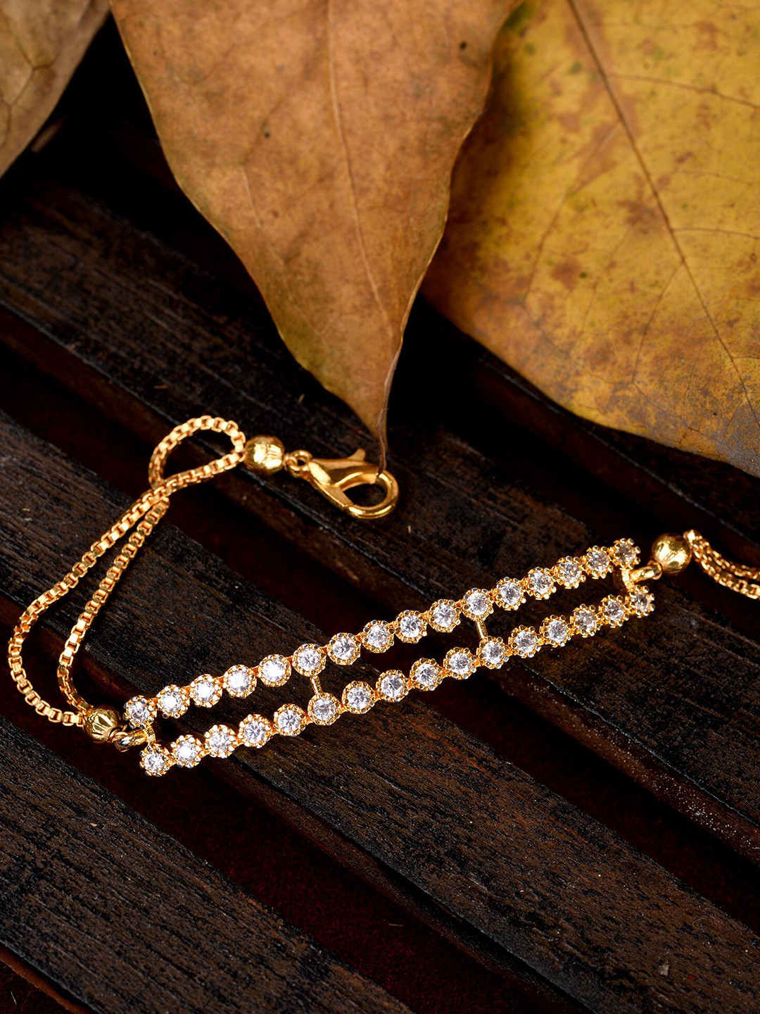Saraf RS Jewellery Women Gold-Toned & White Brass American Diamond Gold-Plated Link Bracelet
Saraf RS Jewellery Women Gold-Toned & White Brass American Diamond Gold-Plated Link Bracelet