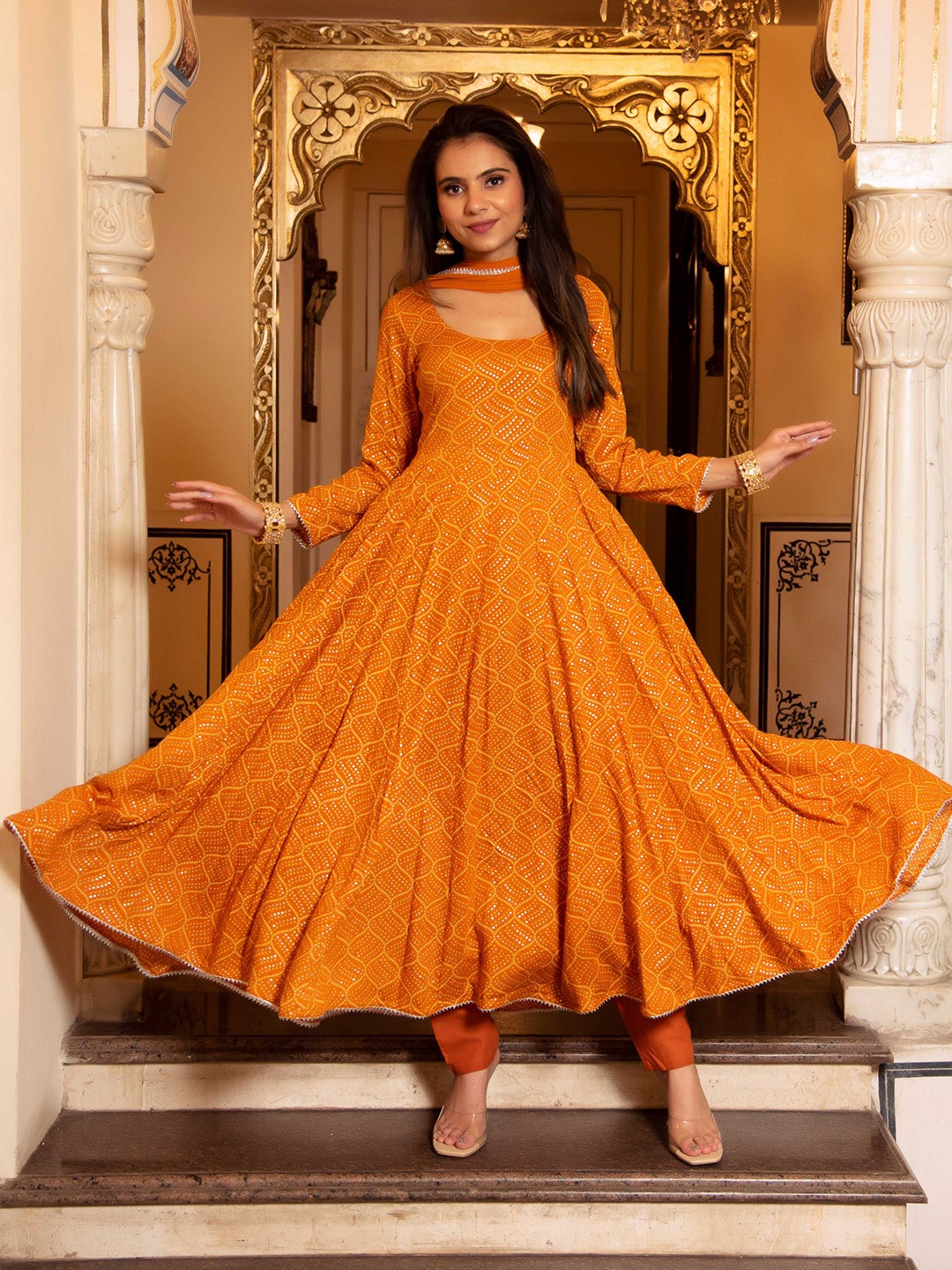 Calmna Women Mustard Yellow Bandhani Printed Anarkali Kurta with Trousers & With Dupatta
Calmna Women Mustard Yellow Bandhani Printed Anarkali Kurta with Trousers & With Dupatta