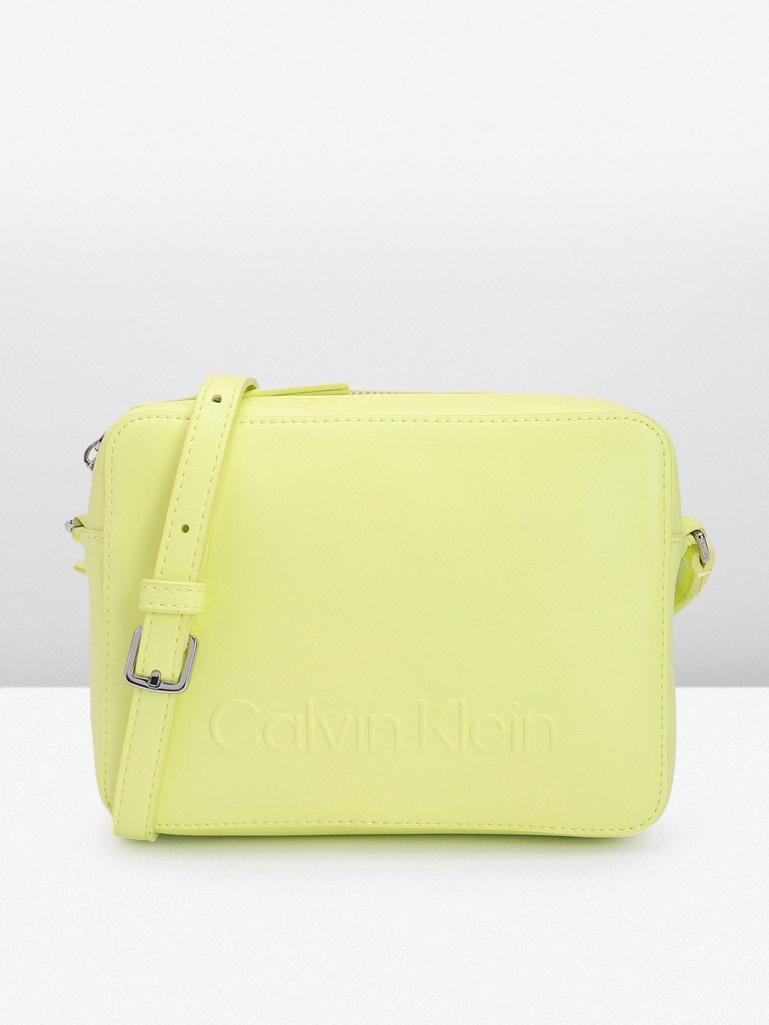Calvin Klein Solid PU Structured Sling Bag With Brand Logo Embossed Detail & A Cover Pouch, Lime green
Calvin Klein Solid PU Structured Sling Bag With Brand Logo Embossed Detail & A Cover Pouch, Lime green